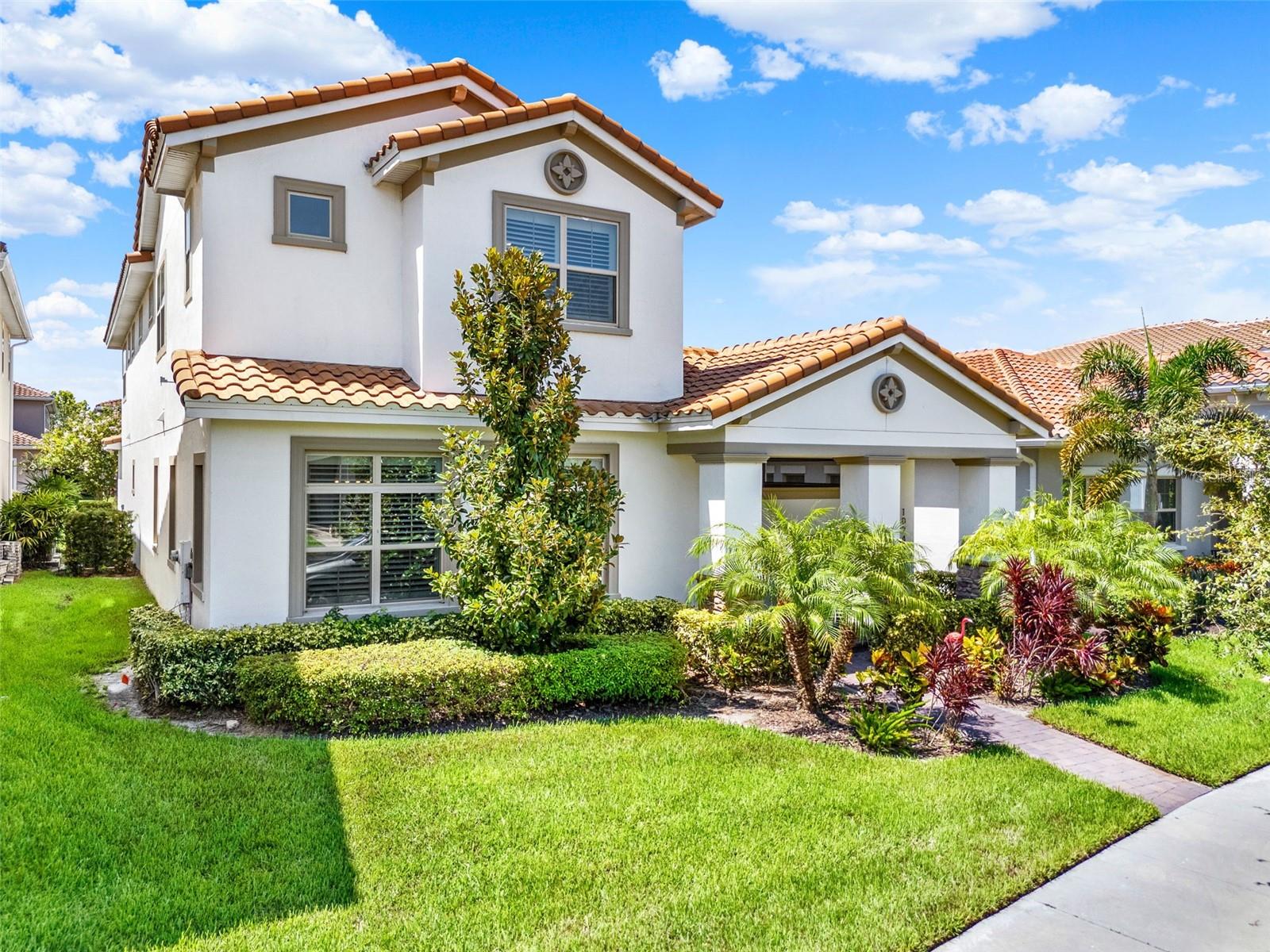 *** Bright & Airy Courtyard Home *** Welcome to 10249 Beechwood Lane, a 3,786 sq ft Mediterranean-inspired residence in the guard-gated golf course community of Eagle Creek in Lake Nona. This two-story home offers FOUR bedrooms, THREE and a HALF baths, and a gorgeous open floor plan CENTERED AROUND AN INCREDIBLE SCREENED IN COURTYARD, the ultimate space for outdoor entertaining. From the moment you arrive, the charm is undeniable. Step onto the welcoming front porch, open the gated entry, and you’re greeted by the first of TWO beautiful OUTDOOR LIVING SPACES, a private front courtyard that opens directly to the family room, perfect for relaxing or entertaining. From here, it’s just steps to the home’s showpiece: a spacious screened-in lanai courtyard at the center of the home. Pre-plumbed for an outdoor kitchen and large enough for a pool, this inviting retreat connects to both the kitchen and the primary suite through retractable sliding doors, blending indoor comfort with outdoor enjoyment. The heart of the home is the chef’s kitchen, designed for both beauty and functionality. A massive center island with quartz counters offers seating for casual meals or a place to gather while cooking. Abundant cabinet space, a walk-in pantry, stainless steel appliances, and elegant pendant lighting make it as practical as it is stylish. Natural sunlight fills the kitchen, dining, and living areas, creating the home’s bright and airy feel. Just off the kitchen, a large laundry room offers built-in cabinetry and countertops, while a convenient drop zone by the garage entry keeps daily essentials organized. The first-floor primary suite is a private retreat with DIRECT ACCESS to the main courtyard and a spa-inspired ensuite featuring dual vanities, a large walk-in shower with, and generous closet space. Upstairs, a spacious bonus room anchors three additional bedrooms and two full baths, providing plenty of space for family and guests. Beyond the courtyards, a FENCED BACKYARD offers even more possibilities, ideal for a pergola, play area, or dog run. Living in Eagle Creek means access to championship golf, tennis courts, fitness center, multiple pools, playgrounds, and a beautiful clubhouse. You can walk right our your FRONT DOOT to the nearby community pool or take a golf cart to Eagle Creek Elementary. With easy access in and out of the neighborhood, you’re just minutes from Lake Nona’s shopping, dining, Medical City, and the airport. With its bright, airy feel, two distinct courtyards, and a design that encourages indoor-outdoor living, this home offers the perfect blend of comfort, style, and community.