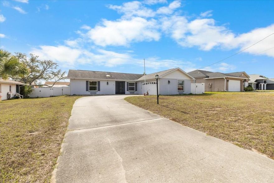 Diamond in the Rough - Priced to Sell! Unlock the potential of this 2-bedroom, 2-bath home offering endless possibilities for investors, renovators, or buyers ready to create their dream space. Featuring wood flooring, white PVC fencing, a screened lanai with vinyl windows and tile flooring, and a side-entry garage, this property is packed with character and opportunity. Major updates include a new A/C (2023) and updated windows and sliding glass door (2018), providing a strong foundation for future improvements. A detached 22x15 garage building with a garage door and side entry offers flexible use as a she-shed, man cave, workshop, or additional storage. An extra spacious storage shed adds even more functionality.This home does need TLC, but with so much potential and multiple outbuildings, the possibilities are endless. Priced to sell—don't miss this opportunity to add value and make it your own!