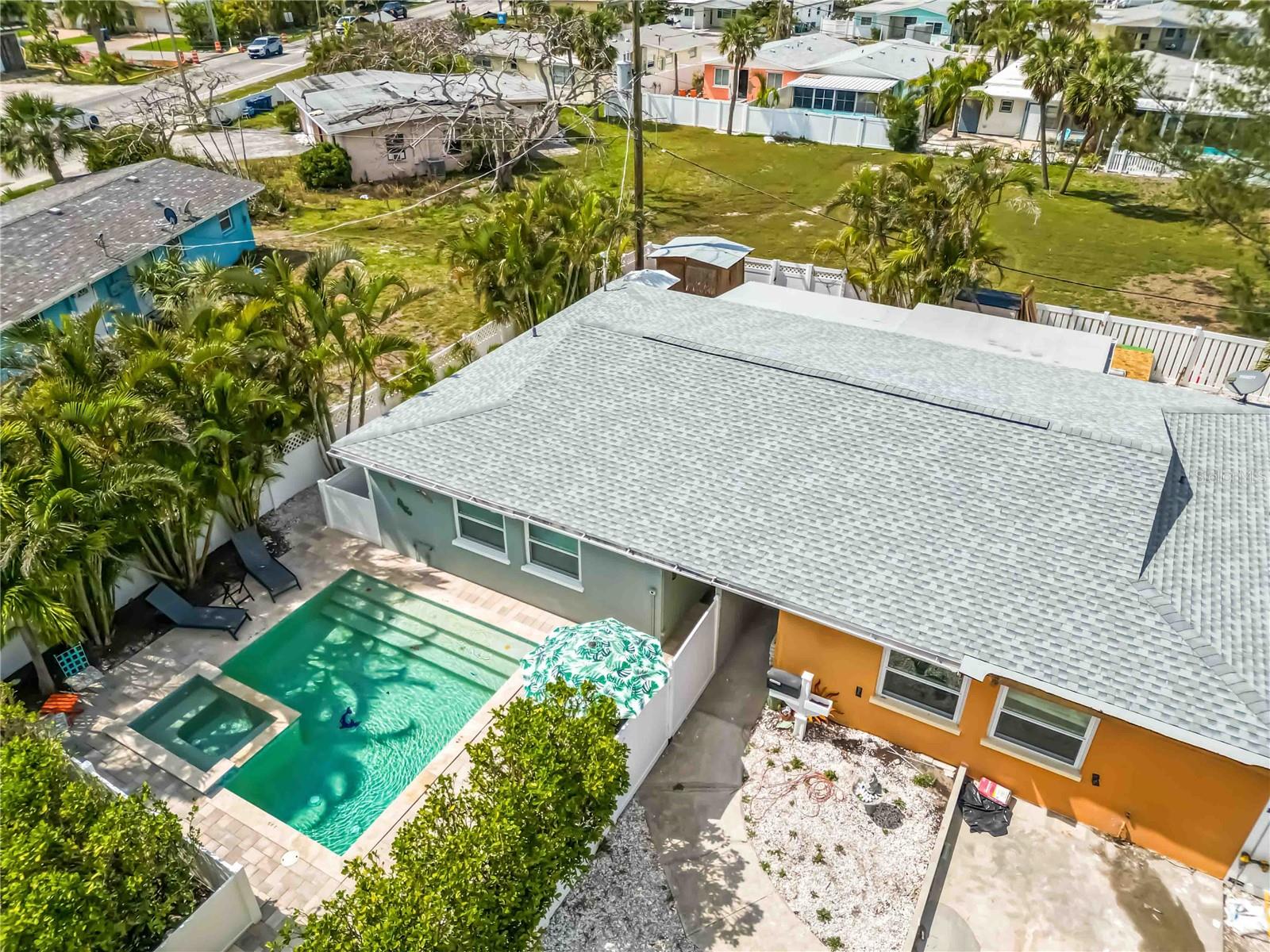 This beautifully restored, income producing property can be yours! Welcome to Island Delight on Anna Maria Island. Offered TURNKEY furnished with an active rental history and brand new roof, this property provides flexible options to enjoy paradise. Primely located just a few blocks from the turquoise waters and powdery sand of the Gulf, you can enjoy the the island's serene beauty whenever you wish. You'll love the private, heated, saltwater pool and spa as you walk through the gates of this charming home--adorned with beautiful pavers. Inside you'll find an inviting space with a large kitchen equipped with all new stainless steel appliances, kitchen cabinetry and fixtures. The granite countertops are a nice touch with bar seating at the peninsula. The bathroom is conveniently positioned between the two spacious bedrooms. The living space boasts an open concept to the spacious dining area, and an exterior door that leads out to your secluded and fenced deck area. The grand back yard space/deck is equipped with a sitting area, grilling space, outdoor shower and adorable shed for all your beach gear. The parking pad is large enough for two vehicles which makes parking on the island seamless! The community of Seaside Gardens has a low monthly HOA fee that includes water which makes owning a pool very cost effective. Even more, you have access to tennis courts, pickleball courts, shuffleboard, basketball court and a playground! With its unbeatable location and income potential, this property is an exceptional investment opportunity.