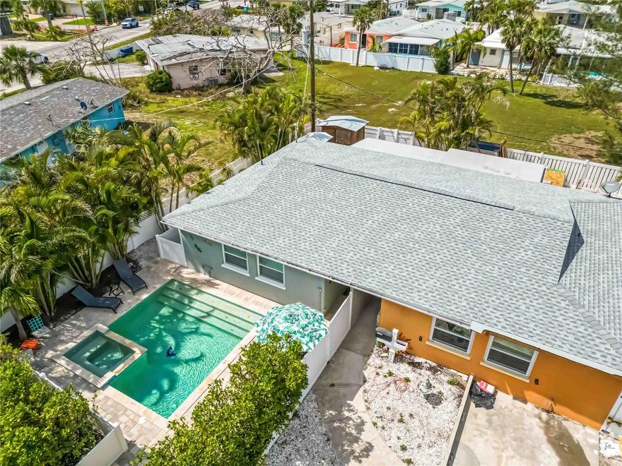 This beautifully restored, income producing property can be yours!  Welcome to Island Delight on Anna Maria Island.  Offered TURNKEY furnished with an active rental history and brand new roof, this property provides flexible options to enjoy paradise.  Primely located just a few blocks from the turquoise waters and powdery sand of the Gulf, you can enjoy the the island's serene beauty whenever you wish.  You'll love the private, heated, saltwater pool and spa as you walk through the gates of this charming home--adorned with beautiful pavers.  Inside you'll find an inviting space with a large kitchen equipped with all new stainless steel appliances, kitchen cabinetry and fixtures.  The granite countertops are a nice touch with bar seating at the peninsula.  The bathroom is conveniently positioned between the two spacious bedrooms.  The living space boasts an open concept to the spacious dining area, and an exterior door that leads out to your secluded and fenced deck area.  The grand back yard space/deck is equipped with a sitting area, grilling space, outdoor shower and adorable shed for all your beach gear.  The parking pad is large enough for two vehicles which makes parking on the island seamless!  The community of Seaside Gardens has a low monthly HOA fee that includes water which makes owning a pool very cost effective.  Even more, you have access to tennis courts, pickleball courts, shuffleboard, basketball court and a playground!  With its unbeatable location and income potential, this property is an exceptional investment opportunity.