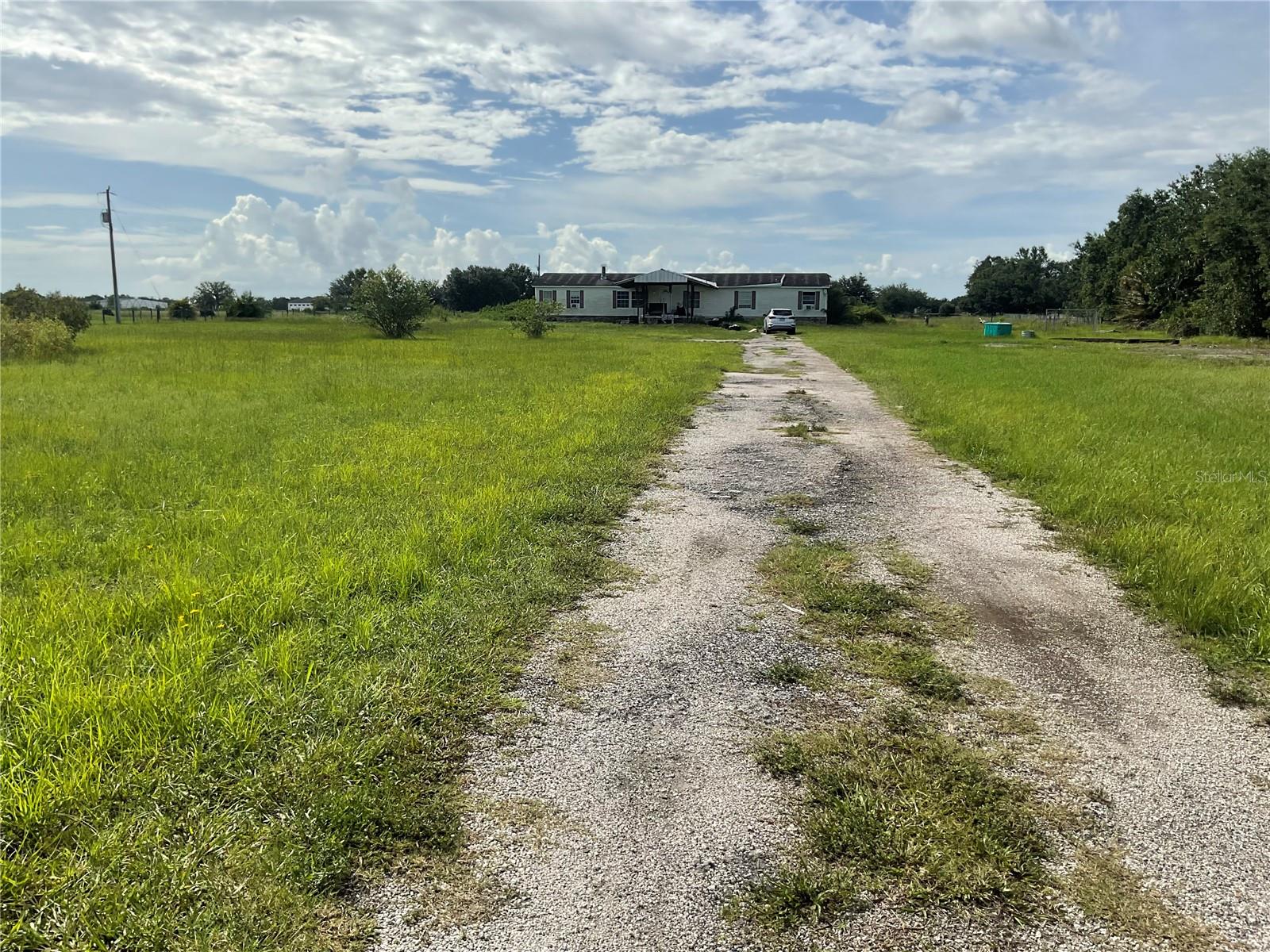 Cleared high and dry 5 acre lot with small pond located on Wauchula Road close to State Road 64 conveniently located to lake Manatee State Park yet close to Lakewood Ranch amenities. Property currently has mobile home that does not convey. Electric, well, septic already in place to build your dream home! small pole barn also on property no HOA or deed restrictions. Priced to sell!!