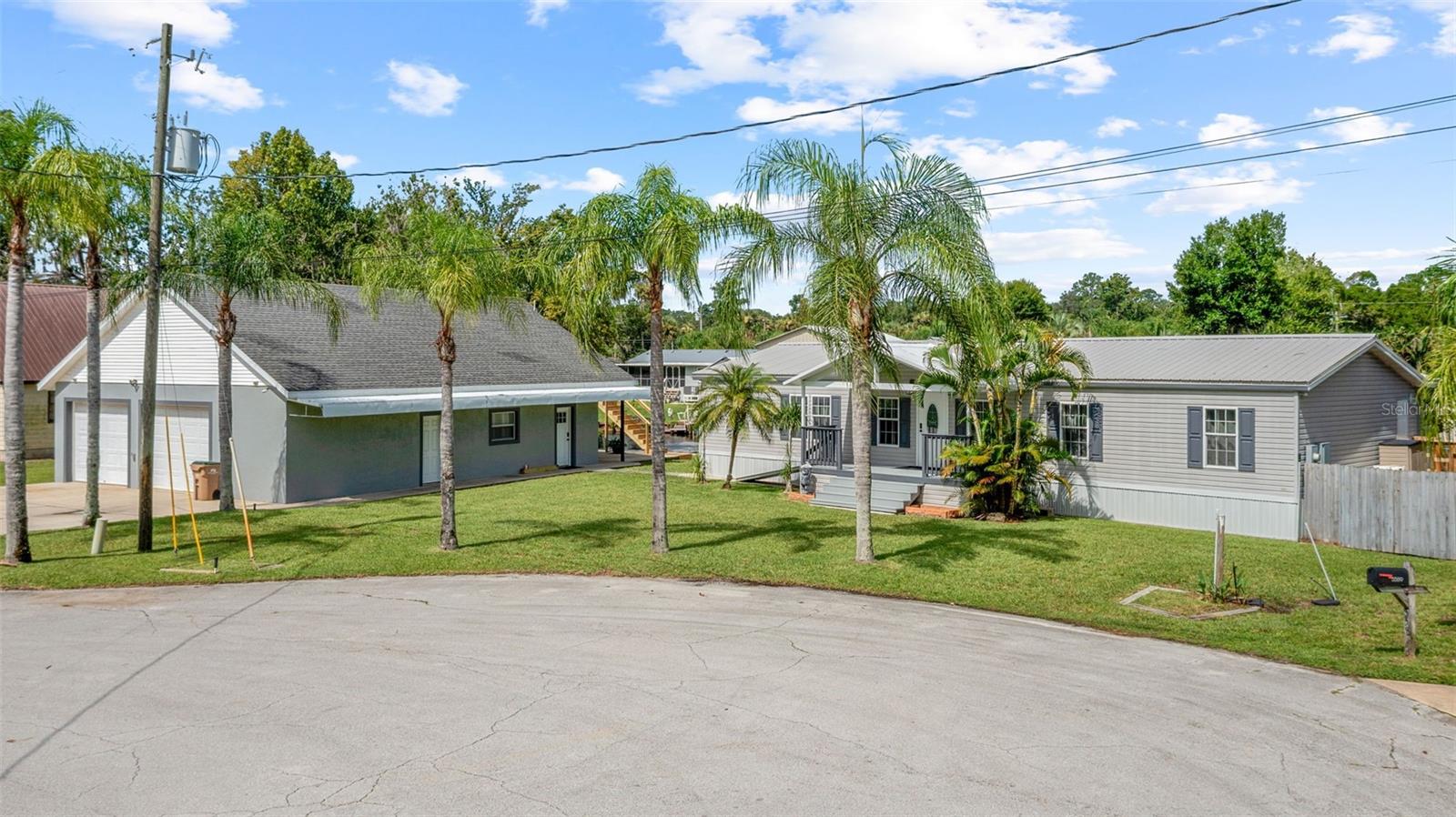 Ideally situated in Astor, FL on one of the widest and deepest canals, this canal-front home delivers a lifestyle crafted for entertaining, comfort, and peace of mind—all just a short cruise to the St. Johns River, Lake George, and the world-famous springs. This is a standout property for boat lovers, families, and investors alike. Step inside to discover a freshly updated interior, beginning with a spacious living area featuring new luxury vinyl plank (LVP) flooring and beautifully refinished ceilings and walls—an inviting space designed for gathering and relaxation. The heart of the home is a fully remodeled kitchen, where Shaker-style, all-wood cabinetry and sealed butcher block countertops pair with stainless steel appliances. An adjacent screened porch overlooks the dock and backyard, offering a tranquil retreat with direct access to outdoor entertaining. The open living room's thoughtful layout includes a built-in bar area with a mini fridge perfect for hosting family and friends gatherings. The split floor plan places two sunlit bedrooms and a full bath on one side, with the entire opposite wing dedicated to the primary suite. This owner's retreat spans the width of the home and features a generously sized bedroom, 1.5 bath, a walk-through closet, and a spa-like bathroom, providing privacy and luxury for homeowners. Outside, a brand-new deck and a whole-house generator (propane-powered) ensure comfort and convenience. Boating enthusiasts will appreciate the 140-foot concrete dock frontage, plus an additional wooden dock room for multiple boats and easy access to the St. Johns River. The possibilities for waterfront entertaining, fishing, and water sports are truly endless. Practicality meets versatility with a detached garage built with poured concrete walls and a rebar-reinforced safe room(16x8)secure storage for vehicles, toys, and valuables. An electric lift simplifies access to overhead storage, and spray foam insulation in the garage maximizes energy efficiency. The bonus room behind the garage is a game-changer: fully equipped with a kitchenette and bathroom, it's ideal for guests, extended family, or even a rental unit (think excellent income potential). This flex space leads to a canal-side patio, perfect for alfresco gatherings. A staircase from the patio leads to an air-conditioned loft and storage room above the garage-endless possibilities for recreation, relaxation, or workspace. Located in a prime, boater-friendly community, with quick access to some of Florida's most scenic waterways, this home excels both as a private retreat and an entertainer's paradise. Flexible living spaces make it an excellent value for buyers seeking waterfront living with room to grow, play, and invest. Contact me today for a private showing!