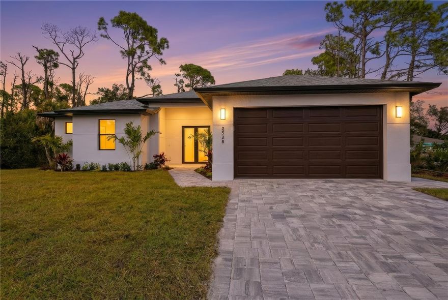 NEW CONSTRUCTION! This thoughtfully designed 3-bedroom home with an additional flex room/office and 2 bathrooms offers modern comfort, clean lines, and low-maintenance living in one of North Port’s fastest-growing areas. The open-concept layout is highlighted by 9'4" ceilings, oversized 24"x48" tile flooring throughout, hurricane-impact windows, and a covered, tiled lanai ideal for indoor-outdoor living. The sleek kitchen anchors the home with quartz countertops, stainless steel appliances, a spacious waterfall-edge island, and ample cabinetry—perfect for casual meals, entertaining, or everyday use. With NO HOA, NO CDD, and NO flood insurance required, this home delivers long-term value and affordability. Conveniently located near I-75 and US-41, you’re just minutes from Cocoplum Plaza featuring Publix, Aldi, Starbucks, HomeGoods, and dining, as well as Wellen Park and CoolToday Park (Atlanta Braves Spring Training), the North Port Aquatic Center, and the new Sarasota Memorial Hospital. Pristine Gulf beaches such as Venice, Manasota Key, and Englewood are all within a 35-minute drive.
Ideal as a primary residence, seasonal getaway, or investment opportunity-this new construction home is a standout!