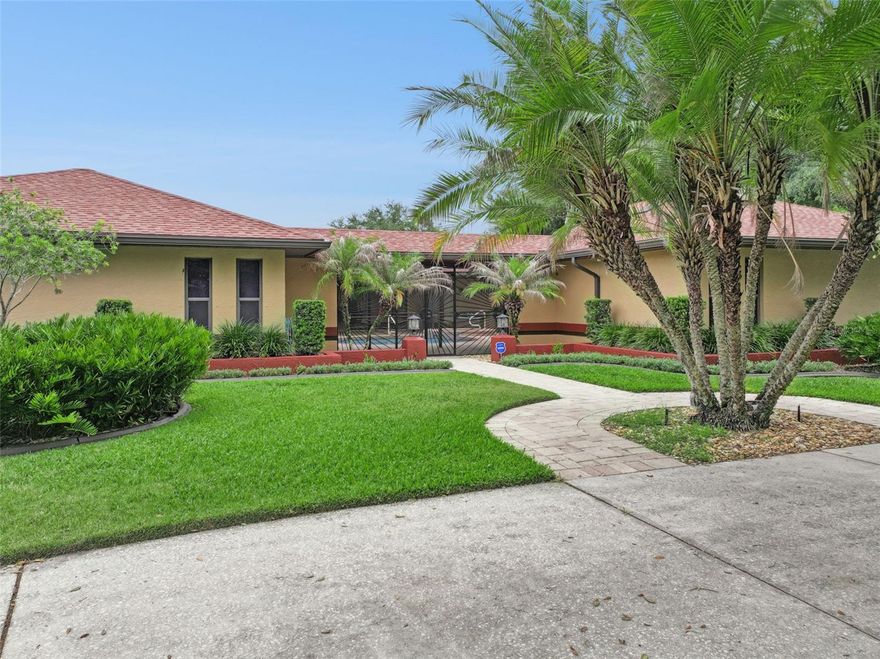 PRESENTING A BEAUTIFUL FLORIDA COURTYARD POOL HOME WITH PRIVATE SETTING! This spacious and well-appointed 4 BD / 2 BA / 1 Half BA residence offers comfort, functionality, and exceptional outdoor living all in one impressive property. From the moment you arrive, you’ll appreciate the expansive layout, oversized 3-car garage, dedicated golf cart parking, and additional storage shed providing plenty of room for vehicles, hobbies, and storage needs. Inside, the home features a bright and spacious living room that flows seamlessly into the large kitchen, creating the perfect setting for entertaining guests or enjoying everyday living. The kitchen is designed with abundant cabinetry, generous counter space, and a convenient breakfast bar ideal for casual dining and gathering with family and friends. The thoughtfully designed split floor plan includes a private in-law suite situated on the opposite end of the home, offering flexibility and privacy for extended family or guests. The primary suite serves as a relaxing retreat featuring an attractive en suite bathroom with dual sink vanity, luxurious glamour tub, and a spacious step-down shower. Just off the primary suite, you’ll find a versatile office/exercise room with its own private exterior entrance — perfect for a home office, fitness space, studio, or peaceful retreat. Step outside and enjoy true Florida living with a screened-in inground pool area perfect for relaxing year-round, while the fully fenced backyard offers privacy and space for pets, play, or outdoor entertaining. Lush tropical landscaping and beautifully maintained grounds create a serene, resort-style atmosphere that enhances the home’s private courtyard setting and curb appeal. The property also includes an RV connection with water hookup, making it ideal for travelers or those needing additional accommodations for recreational vehicles. Additional peace of mind comes with a re-roof completed in 2023. With its combination of spacious interiors, versatile living spaces, exceptional garage and parking options, and inviting outdoor amenities, this beautiful home offers the perfect blend of comfort, convenience, and Florida lifestyle living.