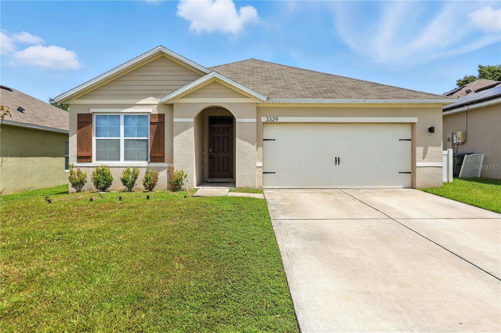 Welcome to this beautifully maintained 3-bedroom, 2-bath home located in the desirable Carlisle Grand community of Davenport. Step inside to a bright, open-concept layout featuring updated flooring, modern fixtures, and a stylish kitchen with stainless steel appliances, a large island, and custom pantry shelving. The spacious primary suite offers a tranquil retreat with a walk-in closet and a stunning en-suite bath featuring dual vessel sinks and a walk-in shower. Two additional bedrooms and a full guest bath provide plenty of room for family, guests, or a home office. Enjoy Florida living with a covered patio and fully fenced backyard—perfect for relaxing or entertaining. The home also includes a 2-car garage and sits just steps from the community pool, clubhouse, and playground. Conveniently located near shopping, dining, theme parks, and major highways for an easy commute, this home blends comfort, style, and convenience in one perfect package.
