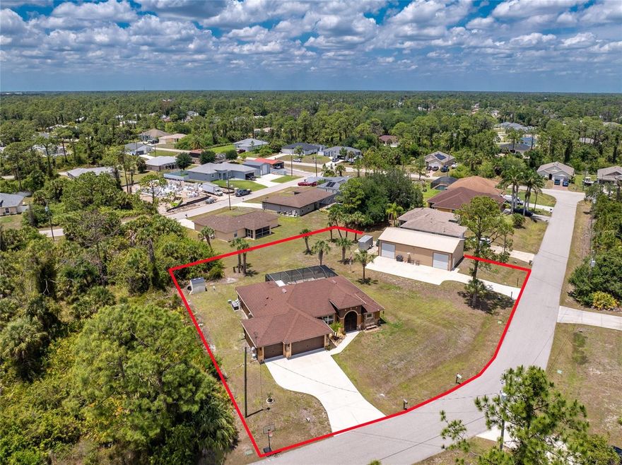 Created with the Collector in Mind! This large pool home combines a 3 car climate controlled garage with a separate steel building built for serious enthusiasts, offering the ideal setup for cars, motorcycles, boats, and weekend projects on a spacious double lot in the X flood zone. Outside, you will appreciate the expanded driveway, multidimensional roof lines, stone accents, and charming curb appeal. Step through the double door screened entry into an open floor plan featuring tray ceilings, crown molding, designer light fixtures and ceiling fans, with a blend of LVP and tile in the main living areas and wet spaces for easy maintenance, and carpeted bedrooms for added comfort. The 8’ triple sliders in the great room extend your living space outdoors while filling the home with natural light. The kitchen is designed for both everyday living and entertaining, offering ample wood cabinetry with crown molding, granite countertops, and a large island. Dining is flexible with a casual breakfast nook or a more formal space accented with decorative wainscoting. The ensuite primary bedroom is spacious and inviting with a tray ceiling, crown molding, sliding doors to the lanai, and dual walk-in closets. The primary bathroom features a fully tiled roman style walk-through shower with dual showerheads, a built-in bench, and separate granite topped dual vanities, including one with an expanded makeup area. Guest bedrooms are well sized with reach-in closets, and the guest bathroom also serves as a pool bathroom for convenience, complete with a tiled tub and shower combo and granite topped vanity. The laundry room includes built-in upper cabinets and a utility sink for added functionality. Step outside to a saltwater heated pool set within a screened lanai that offers both covered and paver areas, creating the perfect setting to relax or stay active year round, with a custom outdoor grill that is negotiable for purchase. The three car garage is equipped with built-in cabinets, a mini split A/C system, and access to a large attic with flooring for additional storage. For even more space, the property includes an impressive 30x50 steel building with two roll-up garage doors, ideal for working on vehicles, storing boats, or housing equipment, with the lift available for purchase separately. Additional features include full hurricane protection with shutters, a private well fed irrigation system, an alarm system, and the option to purchase the home furnished for a truly move-in ready experience. Located at 2089 Mauve Terrace, this home offers convenient access to everything North Port has to offer, with easy access to I 75 for commuting to Sarasota, Tampa, Fort Myers, and beyond. You are also close to shopping, dining, Wellen Park, and just a short drive to Gulf beaches and boating. Positioned between Sarasota and Fort Myers, North Port provides a wide range of dining, shopping, medical services, and outdoor recreation suited for everyday living, with Wellen Park just 10 miles away where you can enjoy Atlanta Braves Spring Training, local restaurants, shopping, and the weekly farmers market.