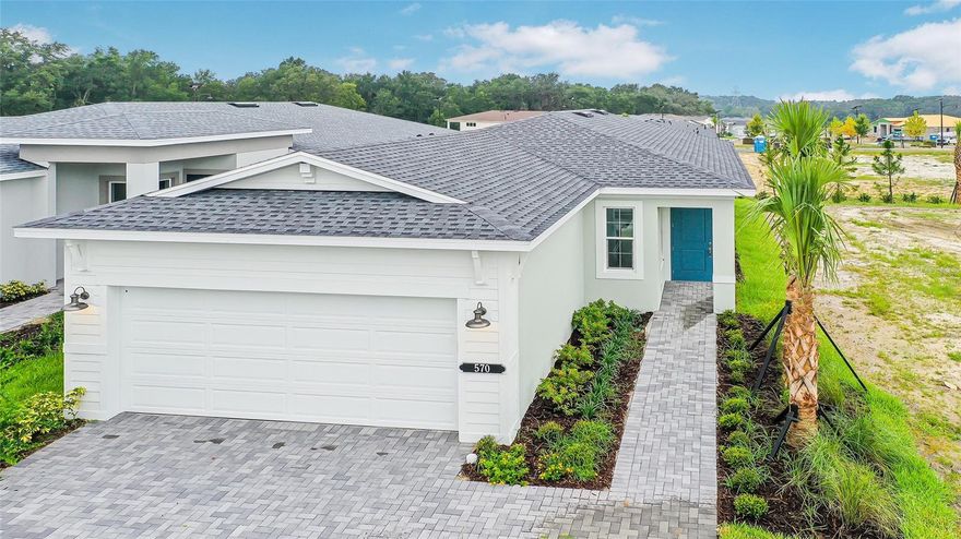 One or more photo(s) has been virtually staged. Pre-Construction. To be built. Cresswind at Hammock Oaks, a new active 55+ community by Kolter Homes, is situated in Lady Lake, FL, famously known as the “home of lakes and sunshine.” Located near The Villages the community is only minutes from Leesburg and convenient to Orlando. This gated community in Central Florida features Cresswind's national award-winning "Set Yourself FREE" lifestyle program based on the cornerstones of Fitness, Relationships, Education and Entertainment. The resident-only clubhouse with a state-of-the-art fitness center and offers 55+ neighbors a place to gather and participate in social activities facilitated by a full-time Lifestyle Director. Outdoor amenities will include pickleball & tennis courts, walking trails, resort-style pool and spa, pool, event and entertainment areas.

Introducing the Ana Floor Plan, a beautifully crafted new construction home designed to fit a wide range of lifestyles. Located in a secure, gated community, this modern 2-bedroom, 2-bath residence includes a flexible Flex Room and a spacious attached 2-car garage—making it an ideal choice for buyers seeking comfort, security, and contemporary design in a thriving neighborhood.
As you arrive, the inviting front porch offers charming curb appeal and a tranquil space to welcome guests or relax outdoors. Step inside to experience an open-concept design, where luxury vinyl plank flooring flows seamlessly throughout the main living areas, providing both durability and on-trend style. The centerpiece of this home is the chef-inspired kitchen, outfitted with frameless European-style cabinets, a deep cabinet above the refrigerator, expanded pot and pan drawer storage, and upgraded large cabinet crown molding. Home chefs will love the upgraded slide-in natural gas range, luxury 3cm quartz countertops, and artisan tile backsplash, creating the perfect environment for meal preparation and entertaining. The large kitchen island connects effortlessly to the Great Room, fostering a sense of unity and allowing for easy gatherings with friends and family.
The thoughtfully designed split-bedroom layout ensures privacy for both the owner’s suite and the secondary bedroom, making this floor plan perfect for families, couples, or those who frequently host guests. The owner’s suite is a peaceful retreat, featuring an expansive closet and a luxurious bathroom with a frameless shower enclosure, upgraded pebble tile shower floor, and brushed nickel plumbing fixtures. Tile-to-ceiling showers and high-quality materials in both bathrooms add an extra touch of sophistication and comfort.
The versatile Flex Room offers endless possibilities, easily transforming into a home office, formal dining area, fitness studio, or additional guest room to meet your changing needs. Laminate wood plank flooring continues into the Flex Room and owner’s suite, while upgraded carpet in Bedroom 2 ensures comfort underfoot.
Outdoor living is an extension of the home with a covered lanai that’s perfect for year-round enjoyment—whether you’re hosting alfresco dinners, relaxing with a book, or grilling with the dedicated natural gas line. Energy-efficient features such as the exterior tankless water heater provide continuous hot water and cost savings. The attached 2-car garage ensures secure parking and ample storage for vehicles, tools, or recreational equipment.