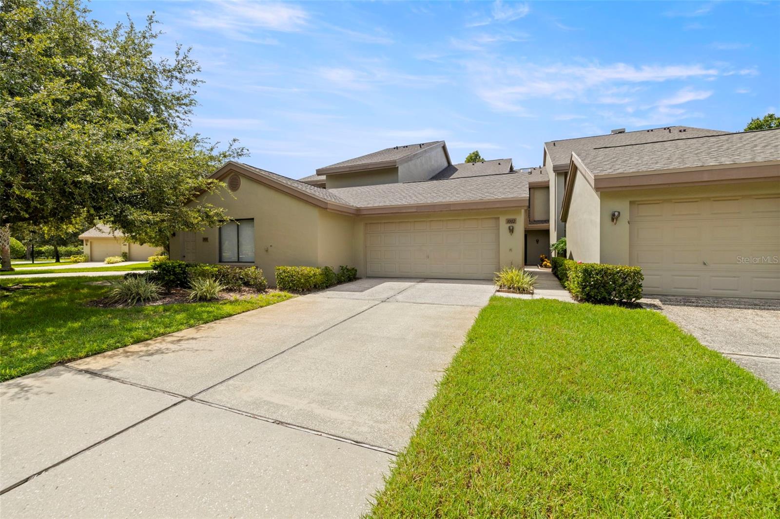 One or more photo(s) has been virtually staged. Welcome to Landmark Oaks in Palm Harbor, a pet-friendly community with no age restrictions. This move-in-ready two-story townhome offers three bedrooms, two and a half baths, and the rare convenience of a private two-car garage.
The open living and dining area is warmed by a wood-burning fireplace and flows seamlessly to a screened lanai with built-in office space and a mini-split system, perfect for work, hobbies, or year-round relaxation. The kitchen features updated wood cabinetry, updated appliances, granite countertops, and a breakfast bar, with a bright dining nook overlooking a private front patio.
Upstairs, the split-bedroom layout provides privacy, featuring a spacious primary suite that overlooks peaceful wooded views. The ensuite bath includes dual sinks and a walk-in closet, while two additional bedrooms share a full bath. Freshly painted interiors, a new water heater (2025), updated air conditioning (2019), and a new roof (2024) provide added peace of mind, along with a clean 4-point inspection.
Step outside and enjoy the sparkling community pool, heated spa, and tennis courts set among lush landscaped grounds. Monthly fees include cable, internet, water, trash, exterior insurance, reserves, and community amenities making it easy to enjoy low-maintenance living.
Centrally located, Landmark Oaks is close to top schools, hospitals, shopping, restaurants, movie theaters, Tampa International Airport, and the Gulf beaches. Whether commuting via McMullen Booth, US19, or enjoying everything nearby, Clearwater, Oldsmar, Tarpon Springs, St. Petersburg, and Tampa Bay. This location makes everyday living simple and convenient.
Landmark Oaks combines comfort, function, and lifestyle, ready for you to call home.