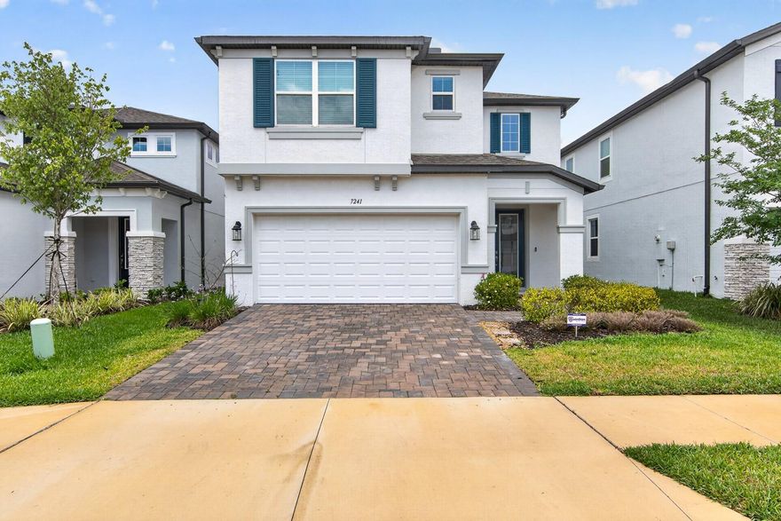 Welcome to the gated community of Whispering Oaks Preserve, where low HOA fees and NO CDD offer exceptional value in a prime Wesley Chapel location. From the moment you arrive, the beautiful curb appeal stands out with pristine landscaping, a paver driveway and walkway, and an upgraded 8-foot front door that opens into a dramatic two-story foyer.

Offering 4 bedrooms, 3 full bathrooms, a dedicated office/flex room, bonus loft, and 2,717 square feet of thoughtfully designed living space, this home provides the perfect balance of functionality and style. The open-concept layout seamlessly connects the living room, dining area, and gourmet kitchen, creating an inviting atmosphere ideal for entertaining and everyday living.

The kitchen is beautifully appointed with granite countertops, a large center island, 42” soft-close cabinetry with crown molding, upgraded hardware, stainless steel appliances including a double oven, and a spacious walk-in pantry. Glass sliders lead to the extended 14x12 covered lanai overlooking the fully fenced backyard, offering plenty of room to relax, entertain, or enjoy outdoor living.

The first-floor flex room with French doors, closet, and nearby full bathroom offers endless versatility and can easily function as a guest bedroom, home office, playroom, or private den. Upstairs, a spacious loft provides additional living space perfect for a secondary family room, media room, or homework area.

The primary suite is a true retreat featuring tray ceilings, a large walk-in closet, and a luxurious ensuite bathroom complete with dual vanities, soaking tub, and upgraded matte-framed shower enclosure. Two additional upstairs bedrooms share a conveniently located full bathroom, while the upstairs laundry room includes sink hookups for added convenience.

Additional upgrades include laminate flooring throughout the main level and staircase, recessed lighting, 5 ¼” Colonial baseboards, Smart Home thermostat, water softener hookup, gutters with underground drains, and a 2-car garage with epoxy flooring.

Residents of Whispering Oaks Preserve enjoy community amenities including a playground, dog park, and EV charging station, all conveniently located near top-rated schools, hospitals, shopping, dining, Publix, movie theaters, Epperson Lagoon, and Wesley Chapel District Park. With easy access to I-75 and I-275, commuting to Downtown Tampa, Tampa International Airport, and MacDill Air Force Base is a breeze.