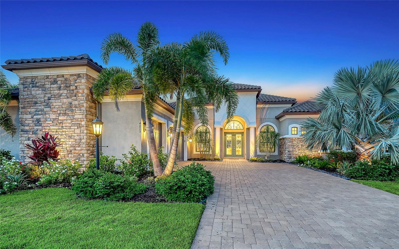 Esplanade Golf Home with Bundled Country Club Membership + Luxury Upgrades! Situated in Lakewood Ranch’s sought-after Esplanade Golf & Country Club, this standout residence includes a bundled Golf & Country Club membership—a rare and highly sought-after inclusion in Lakewood Ranch’s premier resort-style community, Esplanade Golf & Country Club. Not all homes in Esplanade offer this benefit, which grants exclusive access to the private championship golf course, tennis and pickleball courts, resort pool, full-service spa, fitness center, on-site dining, and year-round social lifestyle programming. Set on an oversized 0.279-acre lot with southwest front exposure, this 2019-built home offers 3,662 square feet of elevated living space with high ceilings, an open-concept layout, and private views along the 8th hole—without being directly on the tee box. Enjoy a rare combination of privacy, golf course living, and resort access all in one. Inside, the chef’s kitchen impresses with stainless steel appliances, double-stacked solid-wood cabinetry, granite countertops, a walk-in pantry, and a large eat-in island with storage on both sides. The light-filled great room flows effortlessly to a covered lanai, where a gas-heated pool and spa (16x10) invite relaxation. The expansive outdoor living space features a built-in grill and beverage fridge—the perfect stage for alfresco dining and memorable celebrations. The spacious primary suite features clerestory windows, direct lanai access, two custom walk-in closets, and a spa-style bath with jetted tub and walk-in shower. Two additional bedrooms, a den, a bonus room, and 3.5 baths offer flexibility for guests, hobbies, or working from home. This is one of the most extensively upgraded homes currently on the market in Esplanade. Premium enhancements include a whole-house generator, hurricane impact windows, a tankless water heater, and a climate-controlled 3-car garage with a split A/C system. Located in a gated section of the award-winning Lakewood Ranch community—ranked the #1 best-selling multi-generational master-planned community in the U.S. for six consecutive years—this home offers proximity to scenic nature trails, Main Street and Waterside Place, where residents enjoy a vibrant mix of boutique shops, local restaurants, farmers markets, and community events. All just a short drive from Sarasota’s world-famous beaches and cultural attractions.