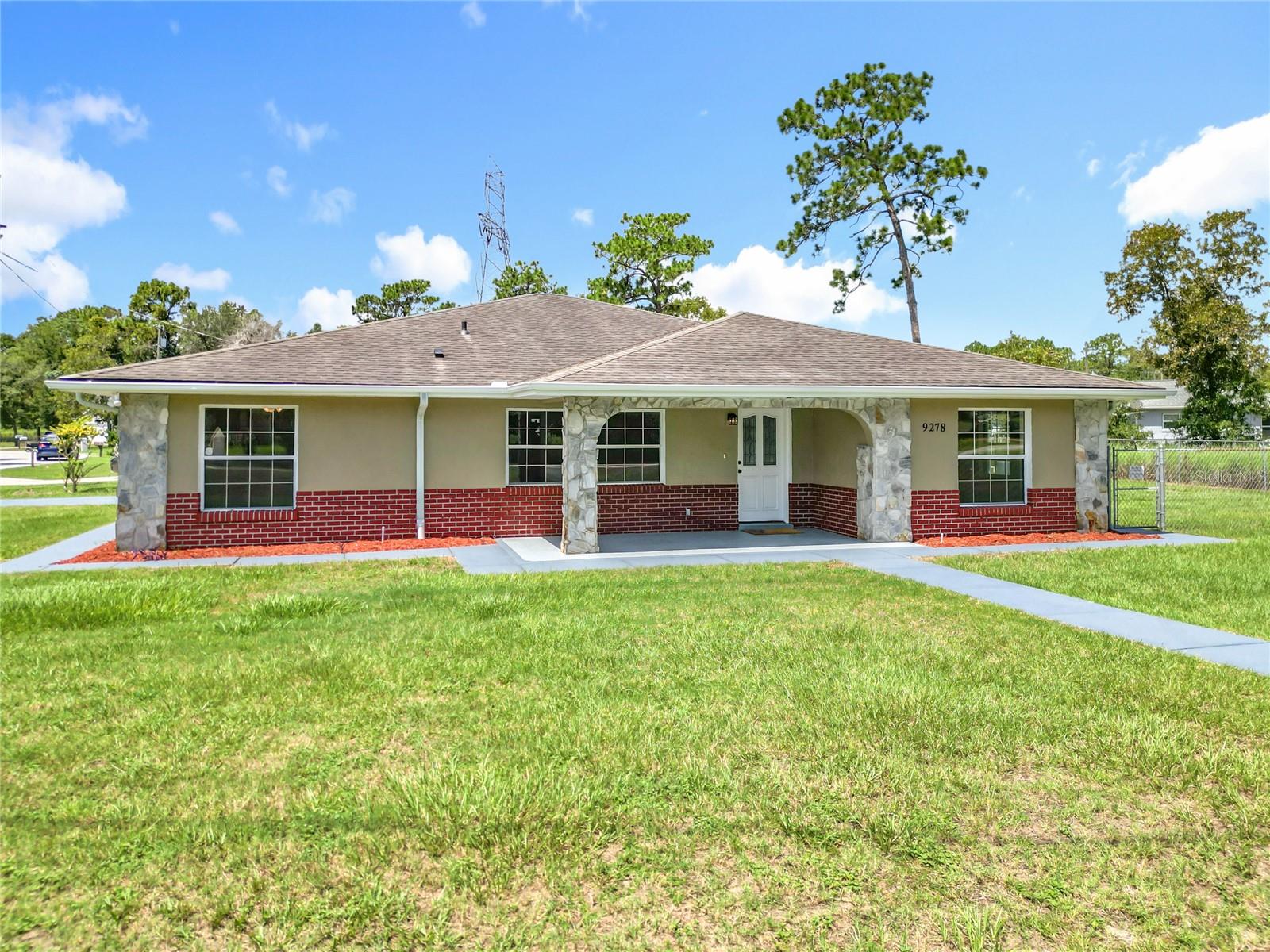 Welcome to 9278 Spring Rd in beautiful Ocala, Florida—a fully renovated 4-bedroom, 2-bathroom home that blends modern upgrades with everyday comfort in one of Silver Springs Shores’ most convenient locations. From the moment you step inside, you’ll be captivated by the fresh and stylish interior, featuring brand-new granite countertops, all-new custom cabinetry, sleek light fixtures, and a premium stainless steel appliance package, including a Samsung refrigerator with an interactive digital screen—perfect for tech-savvy homeowners or anyone who loves a modern kitchen. The bathrooms have been upgraded with new designer vanities and contemporary finishes, and the home is fitted with upgraded ceiling fans throughout for energy-efficient cooling. Enjoy the timeless elegance and durability of tile flooring in the main areas, along with luxury vinyl plank in the kitchen that ties the space together with a clean, upscale look. The floor plan offers privacy and flexibility. Natural light fills the space, and the home has been thoughtfully designed to feel both spacious and welcoming. Step outside to a fully fenced backyard that’s perfect for pets, or weekend gatherings. Whether you're relaxing on the covered front patio with your morning coffee or entertaining guests under the side patio, this home offers the outdoor lifestyle Florida buyers crave. Located in an established neighborhood just minutes from local parks, shopping, dining, and schools, this move-in ready home also offers easy access to downtown Ocala, hospitals, and major roadways.