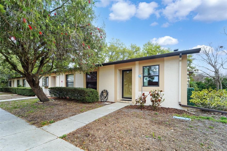 Welcome home Deerwood Gardens! High and dry at 30 feet of elevation! This established villa style condominium community is ideally located in the heart of all that Seminole and Largo have to offer! This spacious end unit features 2 comfortable bedrooms on a split floorplan, 2 full baths, vaulted ceilings, and large windows throughout. After parking in your own covered, assigned parking space right in the front of the unit – step through the bright foyer into your new home! Just inside the entrance, your gourmet kitchen with updated cherrywood cabinets, bar seating and full-size refrigerator await the chef of the home. There is no lack of storage throughout, including the ample pantry just opposite the kitchen, large closets, in-unit laundry with shelving above your machines, AND an enormous utility closet off the sunroom space. This modern floorplan features a completely open concept, blending the kitchen, dining and living areas beautifully together, all enjoying views out to the sunroom and patio. Your primary suite, set to the rear of the unit also boasts a large window overlooking the back green space. The en suite bath includes a large walk-in closet, modern height vanity and sink, plus a remodeled walk-in shower. Unit 21D is walking distance to the club house and heated pool, where lively community events occur around the holidays and throughout the year. Your choice of Publix, all within 10 Minutes, 8 Minutes to Largo Mall, 12 Minutes to the Globally Famous Indian Rocks Beach! 5 Minutes to Walsingham Park and Lake Seminole Park, the largest park in Seminole!