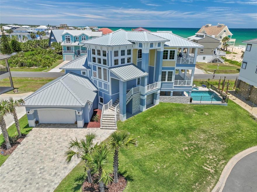 Welcome to your dream oasis by the sea! Nestled just 50 feet from the sandy shores, this custom-built masterpiece is a beacon of luxury living in every aspect. Built in 2023, this home boasts not only timeless elegance but also reliability for years to come.

Prepare to be captivated by the show-stopping front elevation that sets the tone for the remarkable interior within. As you step inside, a grand entryway adorned with modern architecture, voluminous ceilings, and glamorous pillars welcomes you into a realm of opulence.

Spread across three spacious stories, this residence features four bedrooms, three and a half baths, and a three-car garage. The ground floor unveils a private oasis, perfect for guests, with its own wet bar, laundry room, and en-suite bedroom offering direct ocean views and seamless access to the pool deck—a true embodiment of beachfront luxury.

Ascend the hand-crafted oak staircase or opt for the convenience of the elevator to reach the expansive second floor, where the heart of the home resides. An open-concept design seamlessly blends the gourmet kitchen, equipped with top-of-the-line appliances and custom cabinetry, with a family room adorned by a stone fireplace—a perfect gathering spot for intimate conversations or grand entertaining affairs. Step onto the expansive balcony through sliding glass doors from either the family room or the formal dining room and soak in the breathtaking panoramic ocean views.

On the third floor awaits the ultimate retreat—the primary bedroom sanctuary. Here, a private balcony beckons you to unwind and indulge in endless ocean vistas. Luxuriate in the lavish primary bathroom, complete with spacious His/Her closets, a jacuzzi tub, and a meticulously crafted walk-in shower—a true haven of relaxation and rejuvenation.

This coastal haven is not just about luxury; it's also about practicality and peace of mind. With a durable metal roof, hardy board soffits and siding, three HVAC units, two tankless water heaters, propane for gas cooking, and electric blinds, every detail has been carefully considered to ensure comfort and convenience.

This home is a true showstopper, brimming with features too numerous to list comprehensively. Offered FULLY FURNISHED and "turn-key". Don't miss the opportunity to experience the epitome of ocean-side living. Contact us today to embark on your journey to owning this unparalleled coastal retreat.