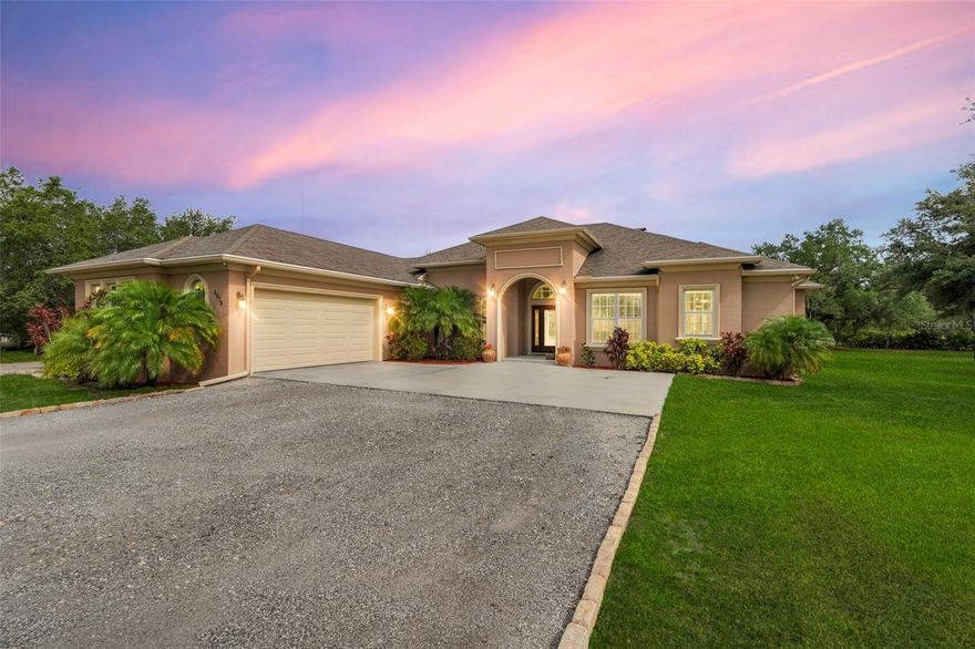 Welcome to a One-of-a-Kind Energy-Efficient Custom Home with Workshop & Outdoor Kitchen in Lake Wales, FL! This is ‘A MUST SEE!’
Make this custom-built, energy-efficient gem your forever home! Nestled on a private, gated 4.79-acre oasis in Lake Wales FL, this stunning 3-bedroom, 3-bathroom home boasts 2,999 sq ft of luxury living with unmatched craftsmanship and efficiency. Step through a solar-powered gate and into elegance via a solid mahogany front door with patina leaded glass. Inside, soaring 10’–14’ ceilings and oversized crown and base molding set the tone, complemented by ambient rope lighting in the great room, primary suite, and above the custom Knotty Alder kitchen cabinetry. This kitchen boasts top of the line stainless steel appliances, Bosch induction cooktop, oven, microwave, LG French Door Refrigerator and an Electrolux 45 Bottle Wine Cooler. Designed with energy performance in mind, this 2016-built home features, Dual Trane 17 SEER HVAC units with hard cast ductwork and individual room return vents. The R-56 insulated attic with foil-backed decking has three solar vents for air circulation. All exterior block walls are Foam-filled with polystyrene board insulation, enjoy the Argon-filled Low-E insulated windows with wood casings, Two Rinnai tankless water heaters, Porcelain tile flooring (reinforced with Schluter DITRA underlayment) extends through high-traffic areas, while both primary suites has custom closet systems. For peace of mind, a reinforced safe room with concrete block walls, 5/8” rebar, and a steel door is built to withstand extreme weather. Perfect for entertaining, the home opens to an 18’ x 12’ screened lanai with a knotty wood ceiling, four ceiling fans, and built-in audio. The adjacent outdoor kitchen includes a Built-In gas grill and LG range with stainless steel vent hoods, granite countertops, faux rock finishes, and ample cabinetry. Bonus features include, a 1,560 sq ft fully serviced, insulated, and AC-cooled workshop with 200-amp electrical service and a 1,300 sq ft front pad—ideal for conversion to living space, Oversized insulated garage doors (18’ x 8’) with R-56-rated insulation, Zoned sprinkler system with raised garden beds and a dedicated water line, 8 security cameras, LED lighting, abundant electrical outlets, Generator-ready electrical/propane hookup, Finished RV pad with underground electric. Located just 15 miles from Legoland and under an hour from Disney World, this exceptional property offers luxury, sustainability, and privacy, making it a true hidden gem in Central Florida. Schedule your private showing today and fall in love with your forever home!