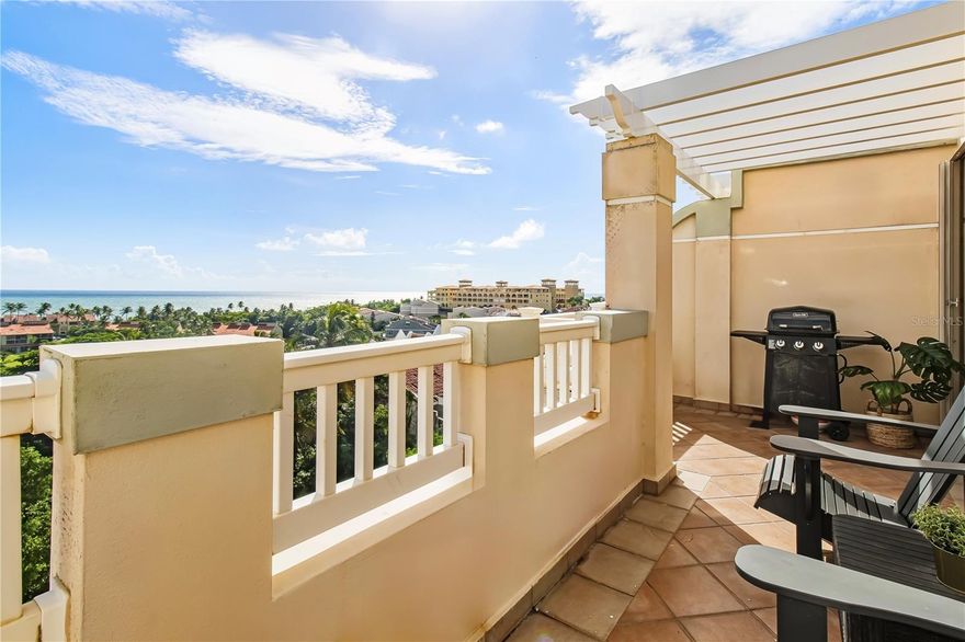Sweeping ocean views, cool tropical breezes and abundant natural light await at this one-of-a-kind penthouse. Unique in both scale and configuration, this residence is one of the few in Palmanova Village to offer four bedrooms, four bathrooms, and expanded square footage. Situated within Palmas del Mar, a premier oceanside resort community, this three-level property rises above the treetops, providing spectacular views of Vieques Island and the Caribbean Sea. 

Spanning approximately 2,400 square feet across three levels, this expansive home embraces indoor-outdoor living with three spacious terraces and a thoughtfully designed layout that provides excellent cross-ventilation and panoramic ocean vistas from nearly every vantage point. The main entrance is located on the second level and features a bright, open concept layout, including a spacious living and dining area, a full bathroom and a vast kitchen that opens onto a small terrace with unobstructed views of the turquoise waters beyond.

The first level offers three bedrooms, two full bathrooms and a dedicated laundry area. The primary suite features a walk-in closet, double vanity, soaking tub and separate shower, while one of the secondary bedrooms benefits from a direct, private entrance. The third level is a true retreat, featuring a grand room with two large terraces that frame stunning ocean and mountain views. Currently configured as an independent suite, this space includes a custom kitchenette and dining area, a full bathroom, a secondary laundry area and an additional loft space, ideal for extra guests. 

Residents benefit from two parking spaces and one golf cart space, along with access to the amenities at Palmanova Village, which include an exclusive pool and fitness center. The exclusive Palmas del Mar Resort is a master-planned coastal community, where residents have direct access to championship golf courses, a world-class tennis center, a full-service yacht club and marina and a renowned beach club. A top-rated school, a variety of shops and restaurants, miles of sandy beach and lush, scenic trails make this East-coast resort one of the most livable communities in the Caribbean. Embrace a rare opportunity to own a versatile, resort-style property that offers the complete Palmas del Mar lifestyle.