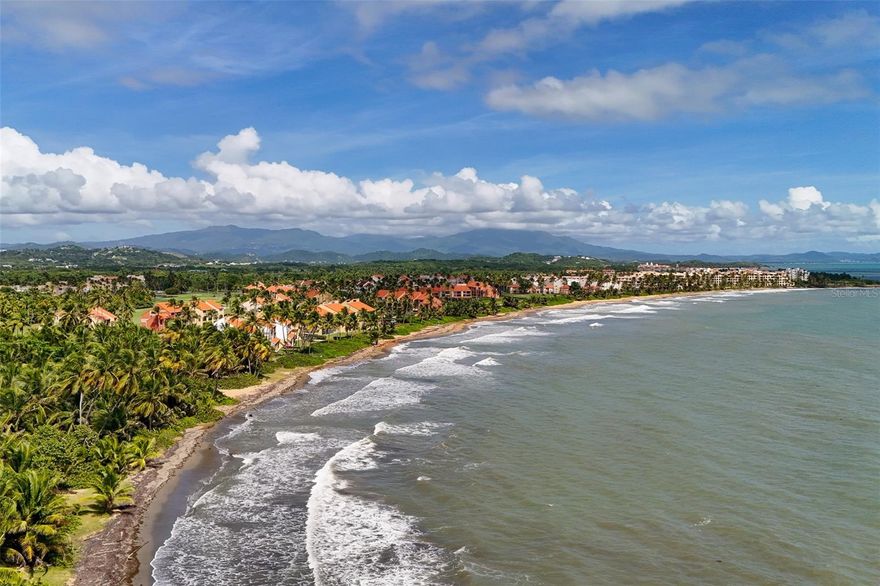 Sweeping ocean views, cool tropical breezes and abundant natural light await at this one-of-a-kind penthouse. Unique in both scale and configuration, this residence is one of the few in Palmanova Village to offer four bedrooms, four bathrooms, and expanded square footage. Situated within Palmas del Mar, a premier oceanside resort community, this three-level property rises above the treetops, providing spectacular views of Vieques Island and the Caribbean Sea. 

Spanning approximately 2,400 square feet across three levels, this expansive home embraces indoor-outdoor living with three spacious terraces and a thoughtfully designed layout that provides excellent cross-ventilation and panoramic ocean vistas from nearly every vantage point. The main entrance is located on the second level and features a bright, open concept layout, including a spacious living and dining area, a full bathroom and a vast kitchen that opens onto a small terrace with unobstructed views of the turquoise waters beyond.

The first level offers three bedrooms, two full bathrooms and a dedicated laundry area. The primary suite features a walk-in closet, double vanity, soaking tub and separate shower, while one of the secondary bedrooms benefits from a direct, private entrance. The third level is a true retreat, featuring a grand room with two large terraces that frame stunning ocean and mountain views. Currently configured as an independent suite, this space includes a custom kitchenette and dining area, a full bathroom, a secondary laundry area and an additional loft space, ideal for extra guests. 

Residents benefit from two parking spaces and one golf cart space, along with access to the amenities at Palmanova Village, which include an exclusive pool and fitness center. The exclusive Palmas del Mar Resort is a master-planned coastal community, where residents have direct access to championship golf courses, a world-class tennis center, a full-service yacht club and marina and a renowned beach club. A top-rated school, a variety of shops and restaurants, miles of sandy beach and lush, scenic trails make this East-coast resort one of the most livable communities in the Caribbean. Embrace a rare opportunity to own a versatile, resort-style property that offers the complete Palmas del Mar lifestyle.