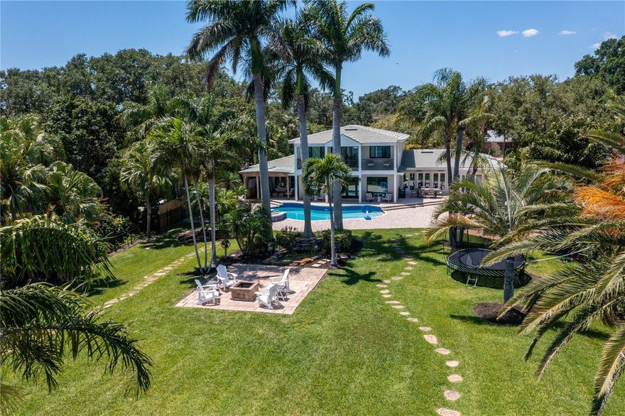 One of the most coveted, breathtaking waterfront lots here in Bahama Shores of St. Petersburg, Florida is now available. This resort-style property is a little over a half acre and is a complete paradise with dolphins and manatees frequently passing by in the water. Also, a pool and spa to lounge in just steps from your private waterfront, directly on Tampa Bay. The backyard oasis is an excellent space for entertaining or creating a majestic garden. The backyard is also where you can enjoy both sunrise and sunset views. The home is perfect for those who are boating enthusiasts with a love of the outdoors and includes a 38,000-lb. lift along with a SeaDoo lift platform and new 220v electric running out to the end of the dock and a brand new seawall with no fixed bridges. The navigable channel provides access to downtown St. Pete or visit the Gulf of Mexico islands just minutes away. This home features a remodeled cook’s kitchen, granite finishes, Thermador gas stove, oversized KitchenAid refrigerator, Miele oven, living room wet bar and 2-car garage. The primary suite upstairs has been completely remodeled as well with marble and quartz finishes in the bathroom and 2 walk-in closets plus you have your own private balcony. This 1957 block-constructed 3,484-square-foot home is on a lot size of 104x270(0.60 acres). The charming Bahama Shores neighborhood is situated just minutes from downtown St. Petersburg, which hosts many great restaurants, museums, and waterfront parks. Just a 15-minute drive to the beaches and 30 minutes to Tampa International Airport.