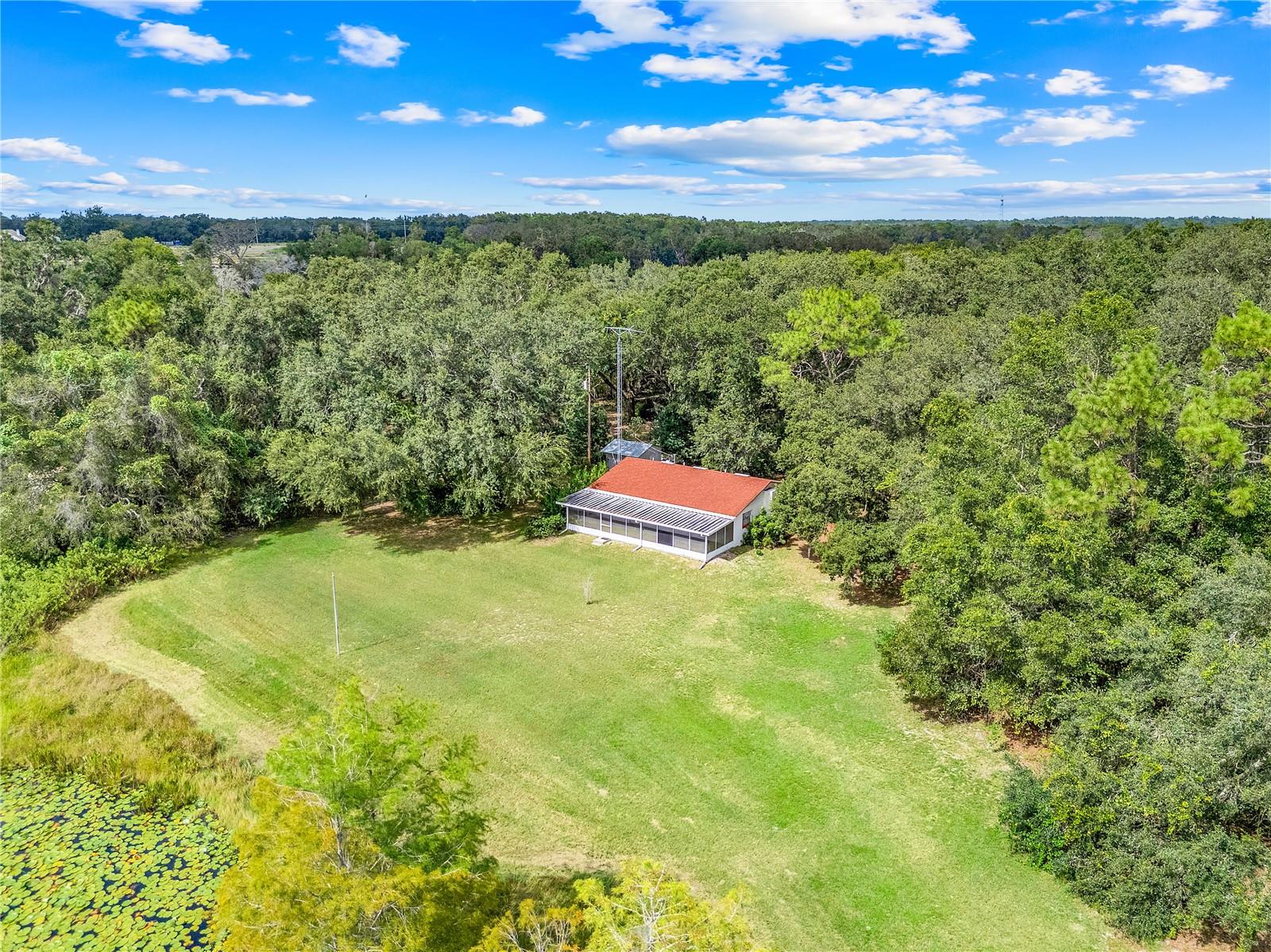 Looking for your very own slice of heaven on Nearly 3 Acres in the heart of Lakefront City? This property has plenty of investment opportunities as well due to R-6 Zoning. The neighboring available property would double your footprint in this beautiful part of Central Florida. The home features 3 Entry Ways and a Large Living Room. The Kitchen and Dining Room provide ample space for those meaningful conversations whether you're the one preparing the meal or relaxing at the table. The Primary Bedroom has 2 Closets for Plenty of Storage. The Refrigerator and Range along with the Washer, Dryer & Electric Water Heater in the Separate Utility Room Stays with the home. You will be near enough for all your shopping and entertainment needs while far enough to experience all the peace and serenity you thought could only be found in your dreams. The sunsets and sunrises are absolutely magnificent across the Leesburg sky and over Robinson Pond. Come see what the buzz is all about because this Will Not Last Long!