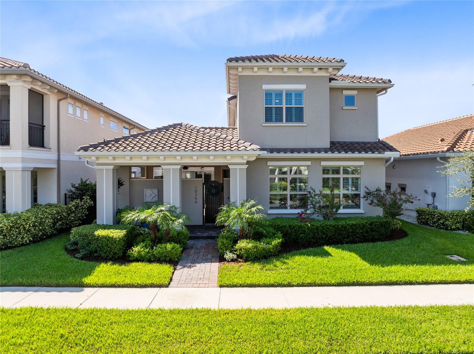 One or more photo(s) has been virtually staged. Welcome to modern Mediterranean luxury in the heart of Eagle Creek Golf Club, one of Lake Nona’s most coveted gated communities. Built in 2021, this meticulously upgraded two-story home blends timeless style with contemporary comfort across 3,784 sq. ft. of beautifully curated living space. With 4 spacious bedrooms, 3.5 baths, a large loft, and an extended garage with a long paver driveway, this home offers room to live, entertain, and thrive.
From the moment you arrive, the barrel-tile roof, covered front porch, and private fenced courtyard set the tone for the home’s elegant design. The outdoor kitchen is a true showstopper, fully covered and equipped with stainless steel cabinetry, Blaze grill, side burner, fridge, and prep space, perfect for weekend cookouts or evening soirees under the stars.
Inside, soaring ceilings and natural light pour into the open-concept layout. The chef’s kitchen impresses with a massive waterfall quartz island, 42” shaker cabinetry, designer backsplash, and premium stainless steel appliances. It flows effortlessly into the spacious living and dining areas, ideal for entertaining or enjoying quiet family nights.
The primary suite is located on the first floor and offers a peaceful retreat with tray ceiling detail, sliding glass doors, dual walk-in closets, and a spa-style bath featuring a super shower with bench, extended dual vanity, and large linen closet. Upstairs, a huge loft offers flexibility for a game room, media space, or second living area.
Other highlights include a bright and functional laundry room with custom cabinetry, energy-efficient systems throughout, and a Mediterranean-inspired exterior with modern flair.
Just a short walk away, enjoy world-class community amenities including a resort-style pool, splash zone, clubhouse with gym and event space, lighted tennis courts, dog park, playground, and multi-use fields. Golf enthusiasts will love having Eagle Creek’s championship course, pro shop, clubhouse, and on-site restaurant just minutes away.
Zoned for top-rated Lake Nona schools and minutes from Medical City, shopping, dining, and the magic of Disney—this home delivers elevated living in a premier location.
Why wait to build? This move-in ready home has it all. Schedule your private showing today!