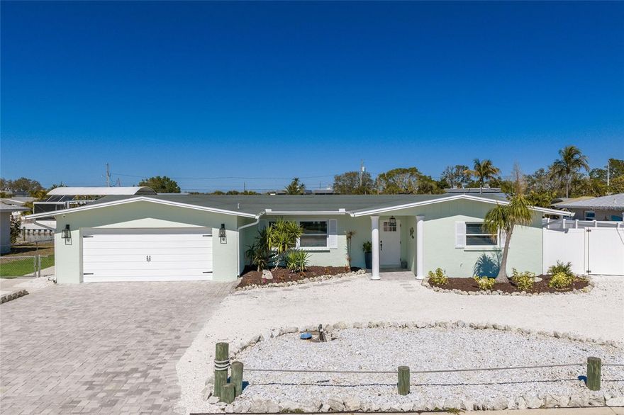 Only 5 photos have been virtually staged with furniture.  Welcome to a boaters dream, do not miss out on this fabulous waterfront home.  This is luxury waterfront living, just minutes by land or water to the sugar-sand beach's and local coastal dining on Anna Maria Island.  Flamingo Cay is a very convenient and lovely waterfront neighborhood positioned right between the island and the mainland, allowing for great access to all that west Bradenton also has to offer including dining , shopping , parks and recreation, golf courses, movie theater's, museums, and much more.  This exceptional 3 bedroom 3 bath pool home offers you a completely updated new kitchen, featuring new cabinets, new fixtures, new quartz counter tops, all new appliances, and new flooring.  It is hard not to notice the wonderful open floor plan, where the kitchen is in the middle and is perfect for entertaining featuring one large island and a breakfast bar great for food and beverage set up .  In addition to the new interior spaces,  there is a new roof, new AC , hot water tank, pool pump, and all new fresh paint inside and outside.  The primary bedroom also has a large bonus room.  This space is large enough for an office, nursery or media room, currently being used as a second extra large walk in closet.  It is also large enough to add an island in the middle for more storage, or clothing and a folding area.  The home also has a second en-suite bedroom bath convenient with its own exit to the pool and backyard patio perfect for when you have overnight guests. Plenty of parking out front with the circular drive and the 2-car garage provides plenty of space and storage.  The backyard offers over 90 feet of water frontage with a brand new seawall and direct access to the inter-coastal where you can experience beautiful sunsets or dining at one of the many waterfront restaurants in just minutes. As far as this lovely home goes, there really is absolutely nothing to do but to bring your boat and start living your best Florida life.  Do not let this one slip away or miss out on your opportunity to live on the water.