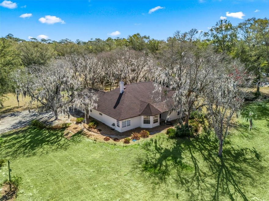 Excellent condition & location describes this house on an 3 acre corner lot within hacking & golf cart distance to the World Equestrian Center Ocala, yet located in a quiet horse friendly neighborhood with no HOA. The property has gorgeous oak trees, is level, & well designed to be able to accommodate a barn, arena & paddocks. The existing 3 bedroom plus office home is concrete block construction, has an attached 2 car garage, & is move-in ready with recently replaced roof, soffits, fascia, electric service, HVAC, hot water heater, & the exterior has been re-painted. The house interior has a generously sized kitchen with granite countertops, pantry & tile flooring. The over-sized primary bedroom opens to the Florida room & has an en-suite 5-piece bathroom with dual walk-in closet. Surrounded by gorgeous horse farms, but close to shopping, restaurants & amenities- this property is a must see!