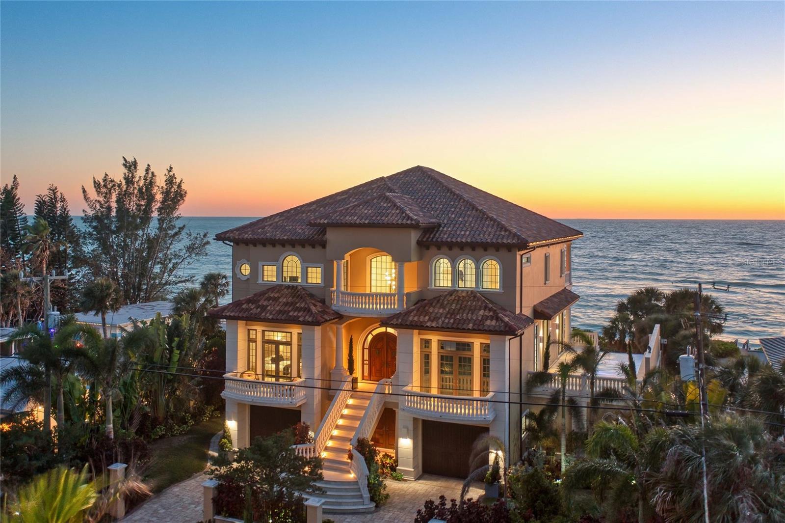 Auction Property. AUCTION BIDDING OPEN: Bidding ends 6/26. Previously listed at $6.445M. Current high bid $4M.
An architectural masterpiece awaits on Casey Key, where traditional Gulf Coast charm meets bold contemporary design in this magnificent 2018-built waterfront estate. Spanning 6,335 square feet of refined living space, the residence captivates with soaring ceilings and dramatic walls of glass framing endless Gulf of Mexico panoramas and spectacular sunset vistas. Meticulously crafted for seamless indoor-outdoor living, the open-concept interior flows effortlessly to expansive terraces and an infinity-edge pool overlooking tranquil waters. The gourmet kitchen showcases premium Italian Cucina cabinetry, sophisticated Dekton countertops, and professional-grade Miele and Bosch appliances. Four luxurious bedroom suites provide sumptuous accommodations, while a state-of-the-art media room, elegant gas fireplace, and comprehensive Crestron home automation system elevate the living experience. This extraordinary property represents the pinnacle of Gulf Coast luxury, offering discerning buyers an unparalleled opportunity to embrace the coveted Casey Key lifestyle in absolute comfort and style.