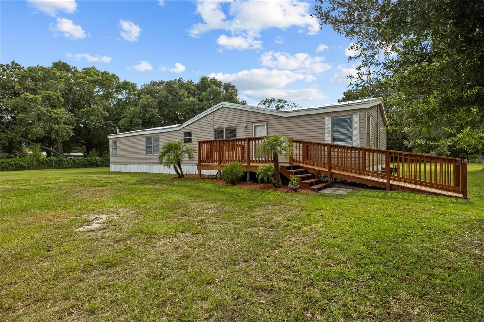 Welcome to your beautifully remodeled double wide mobile home nestled on .88 acres in Auburndale, Florida — offering the perfect blend of space, style, and freedom with no HOA restrictions! Quick access to nearby restaurants, stores and Interstate 4!
This spacious, split floor plan with 3-bedrooms, 2-bath home boasts over 1,700 square feet of upgraded living space, including a family room with a stunning stone fireplace, separate living room, formal dining area, and a kitchen designed for both beauty and functionality!
Step into a bright, fresh interior featuring all new ceiling fans and light fixtures, laminate plank flooring, new carpet, and granite countertops in all wet areas. The kitchen is a showstopper with soft-close cabinetry, stainless steel appliances, and tons of storage for all your culinary and hosting needs!
Outside, enjoy your private slice of Florida — the fully fenced yard (chain-link) offers room to roam, and the large shed with a heavy duty roll up door (barn style type doors as well, but need to be installed) and is perfect for tools, toys, or extra storage!
Whether you’re entertaining in the family room, relaxing by the fire, or enjoying the freedom of nearly an acre with no HOA, this property is ready to welcome you home!
*Features and Updates* Goodman Heat Pump AC unit installed in 2023, Metal Roof installed in 2023, Septic pumped in 2025, Hot water heater replaced in 2023, Electrical wiring throughout with new plugs and switches done in 2023.