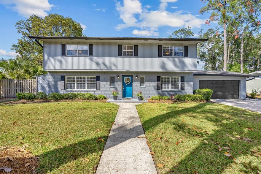 Nestled in the highly desirable Suburban Heights neighborhood, this meticulously maintained two-story brick home is the perfect blend of comfort, functionality, and style. From the moment you step inside, you’ll appreciate the attention to detail and thoughtful updates throughout.
The first floor features a versatile fifth bedroom or office, along with a convenient half bath. The living and dining room combination flows seamlessly, creating an inviting space for everyday living and entertaining. The remodeled kitchen is a true centerpiece, offering modern finishes and an efficient layout. Upstairs, you’ll find four spacious bedrooms and two beautifully remodeled baths. Three of the bedrooms include expansive walk-in closets, and the primary suite boasts its own ensuite bath for comfort and everyday ease. Additional highlights include an indoor laundry room with sink, and the absence of carpet throughout the home, with beautiful oak floors upstairs and wood-looking tile downstairs. The true WOW FACTOR lies in the outdoor living space. A huge covered patio easily accommodates both dining and seating areas, overlooking a sparkling pool and plenty of yard space with mature landscaping. The fully fenced yard provides both beauty and a sense of retreat, making it ideal for relaxation or entertaining. Conveniently located near HCA North Florida Hospital, the University of Florida, Shands, as well as grocery stores, shopping, and dining, this home offers both tranquility and accessibility. This Suburban Heights gem is the perfect place to call home.