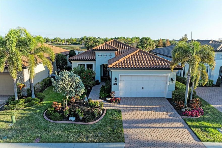 Designed for effortless living and entertaining, this beautifully upgraded residence is located in the gated Country Club East community of Lakewood Ranch.  This popular WCI San Remo floorplan offers a thoughtfully designed blend of modern elegance and everyday comfort, featuring 3 bedrooms, 2.5 baths and a private office.  From the moment you enter, the attention to detail is evident. 8-foot doors, 5 ½” base molding, 5 ¼’’ crown molding, high ceilings, upgraded designer lighting, and neutral tile laid on the diagonal create a bright, refined atmosphere throughout the home.  The heart of the home is designed for seamless indoor-outdoor living and entertaining. A wall of sliding glass doors open to a spacious covered and extended travertine lanai with southeast exposure, offering comfortable temperatures, abundant natural light, and tranquil views through a clear-view screen.  The fully equipped outdoor kitchen includes a grill with hood, refrigerator, sink, and outdoor polymer cabinets with pull-outs ideal for relaxed gatherings or evening dinners outdoors. Inside, a chef’s kitchen impresses with KitchenAid stainless steel appliances, granite countertops, large center island, 42” solid-wood cabinetry with crown trim, soft-close drawers, under-cabinet lighting and a two zone wine refrigerator, all flowing effortlessly into the main living area.  The primary suite serves as a private retreat, highlighted by a generous walk-in closet with custom built-ins and a beautifully appointed bath featuring dual vanities and an oversized glass-enclosed walk-in shower, creating a spa-like escape at the end of the day.  A thoughtfully designed split-bedroom layout provides privacy for guests with two bedrooms and a full bath located in a separate area of the home.  Additional upgrades include custom closet systems, recessed ceilings, a central vacuum system with kitchen toe-kick, sound-reducing insulation in the baths and laundry room, ceiling speakers in great room and lanai areas, dimmer lighting throughout, and outdoor holiday lighting outlets with a single interior switch.  Residents of Country Club East enjoy exclusive access to two private amenity centers.  The Retreat, featuring a resort-style pool, fitness center, and social gathering space and the Residents Club, offering an additional pool and volleyball court.  Optional memberships are available at the Lakewood Ranch Golf & Country Club, proving 72 holes of championship golf, tennis, pickleball, dining and social activities. Ideally located, Country Club East offers convenient access to Waterside Place, Lakewood Ranch Main Street, UTC shopping and dining, world-class Gulf Coast beaches, and SRQ International Airport.  This exceptional home delivers the perfect balance of luxury, comfort and Florida lifestyle, offering a relaxed yet refined way of living in Lakewood Ranch.