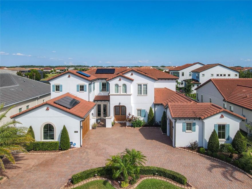 Prepare to be awed by this stunning estate from the Toll Brothers executive collection in the renowned community of Lakeshore Preserve. This home presents an ultra modern layout bringing you an environment that caters to both entertaining and every day life. The first floor is open and has 2 sets of triple pane sliding glass doors that fully open to your personal oasis. Beyond the covered lanai is a beautiful pool, spa and cabana area, perfect for a mid day swim or watching Disney fireworks at night. The kitchens, indoor and outdoor, and sure to impress even the most fastidious of chefs with the natural gas cooktop, multiple mounted range hoods, quartz countertops and more. This property is not only a "smart home" but also environmentally conscientious with newly installed solar panels and an electric car charger. All furniture is included with the sale of this home, the only thing you need is the keys to begin living your best central Florida life. Virtual Tour Available.