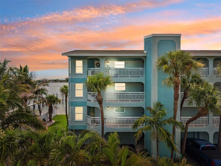 Stunning CORNER WATERFRONT CONDO with Panoramic Pass-a-Grille Channel Views!  Experience luxury waterfront living in this completely RENOVATED corner condo at the exclusive 9-unit Flamingo Bay Club in Tierra Verde. With 180-degree panoramic water views, this 2-bedroom, 2-bath residence defines living the Florida lifestyle — where breathtaking sunsets and abundant marine life are part of your daily life.  The condo has been meticulously redone with impeccable attention to detail throughout. Highlights include elegant Spanish porcelain tile floors, HURRICANE IMPACT WINDOWS, and an open-concept floor plan. The spacious living room features a wood-burning fireplace, while the chef’s kitchen boasts quartz countertops, custom wood cabinetry, stainless steel appliances, induction cooktop, and custom LED lighting. The primary suite offers direct balcony access, a custom walk-in closet, and a spa-like ensuite bath with dual vanities and a walk-in rain shower. Step outside to the expansive 50-foot balcony and enjoy sweeping views of the Pass-a-Grille Channel, Shell Key, Pass-a-Grille Beach, and the iconic Don CeSar Hotel. Additional features include an OVERSIZED 1-CAR GARAGE plus two extra parking spaces, a private dock with kayak lift, a tropically landscaped pool, and recent community upgrades including a NEW SEAWALL and DOCK. Perfect as a full-time residence or coastal getaway, this stunning waterfront condo offers the very best of Tierra Verde living.