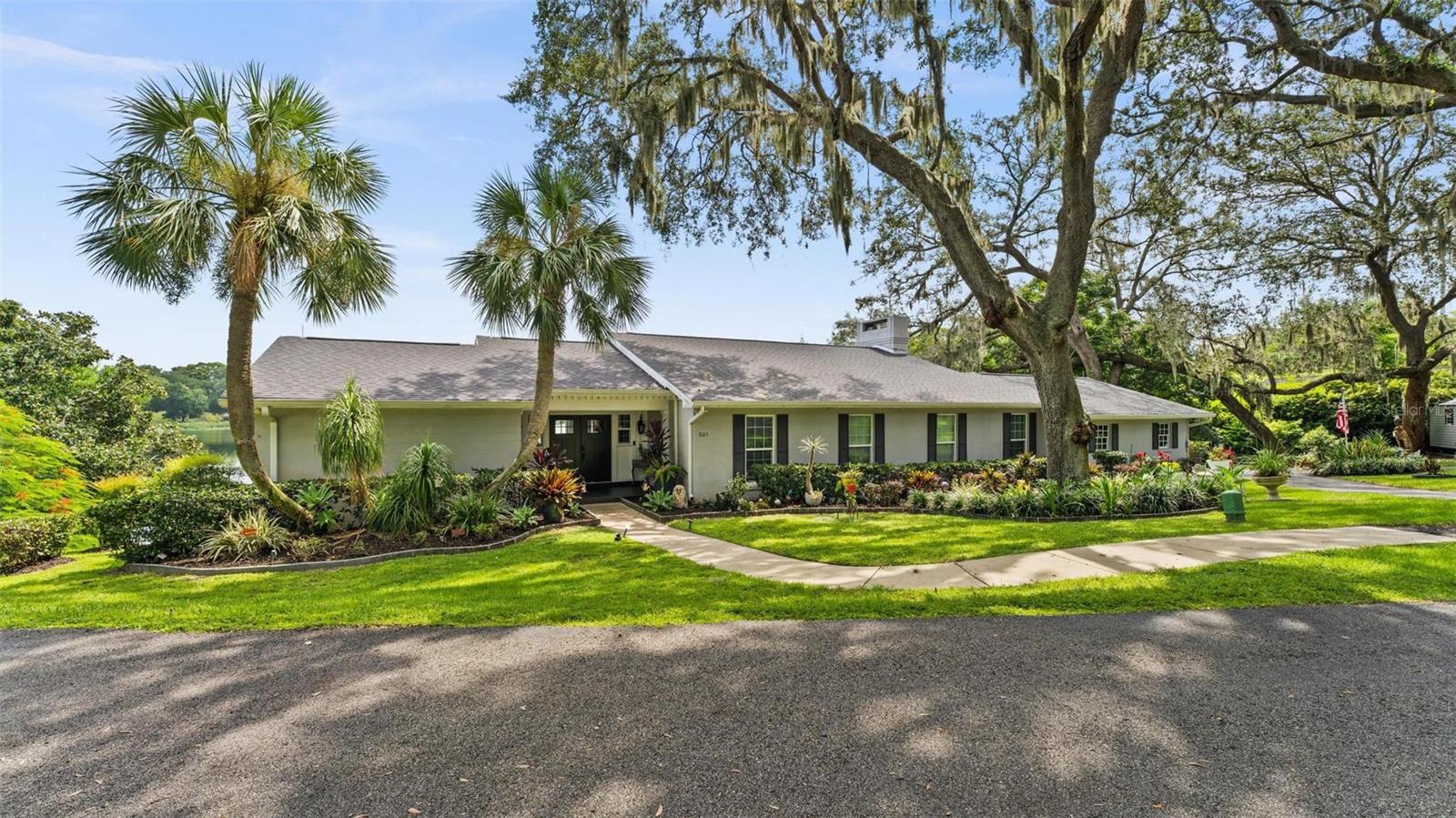 Homes like this don't pop up everyday... This recently (2025) remodeled modern style home is waiting for you to make memories! The owners didn't take any short cuts with the remodel from 24x48 porcelain tiles to upgraded SS appliances, to new kitchen cabinets and countertop, to upgraded bathrooms & brand new garage door & roof!! The home also offers a transferrable termite bond, foam insulation in the walls, lighting rods, concrete seawall, wooden dock, outdoor kitchen & patio. All of this goodness on almost 1 acre with mature landscaping, 200 year old oaks and of course waterfront. Lake Louise is a private 19 acre water haven that is full of activity from skiing, paddle boarding, kayaking & more... It's not just pretty to look at it's nice to USE. So wether you are ready to hit the lake or cook out on the outdoor kitchen or relax in front of the wood burning fireplace or snuggle in for movie night in the downstairs entertainment room or soak in the million dollar view from the Florida/Sunroom this house has it all!