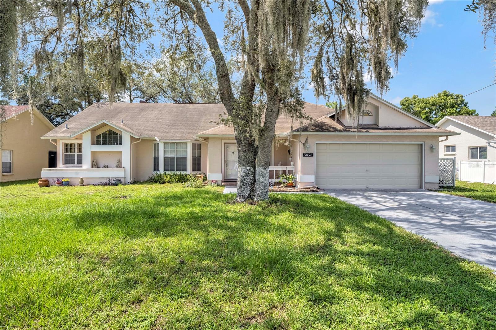 Welcome home to this well-maintained 3-bedroom, 2-bath gem located on a quiet street in a highly desirable area of Spring Hill. With nearly 1,600 square feet of living space, this home offers the perfect blend of comfort, functionality, and Florida charm. Inside, you’ll find a spacious open layout with abundant natural light, a generous living area, and a cozy dining space ideal for everyday living or entertaining guests. The kitchen features ample cabinetry, great counter space, and a view out to the backyard—perfect for staying connected while you cook. The split floor plan ensures privacy, with a spacious primary suite that includes its own ensuite bath and large closet. Two additional bedrooms are comfortably sized and share a full guest bath. Step outside to a fully fenced backyard—ideal for pets, play, or gardening—and enjoy peaceful mornings or evening breezes from your covered lanai. No HOA, or CDD fees! Conveniently located near shopping, dining, schools, and major highways, this home offers everything you need for relaxed Florida living.