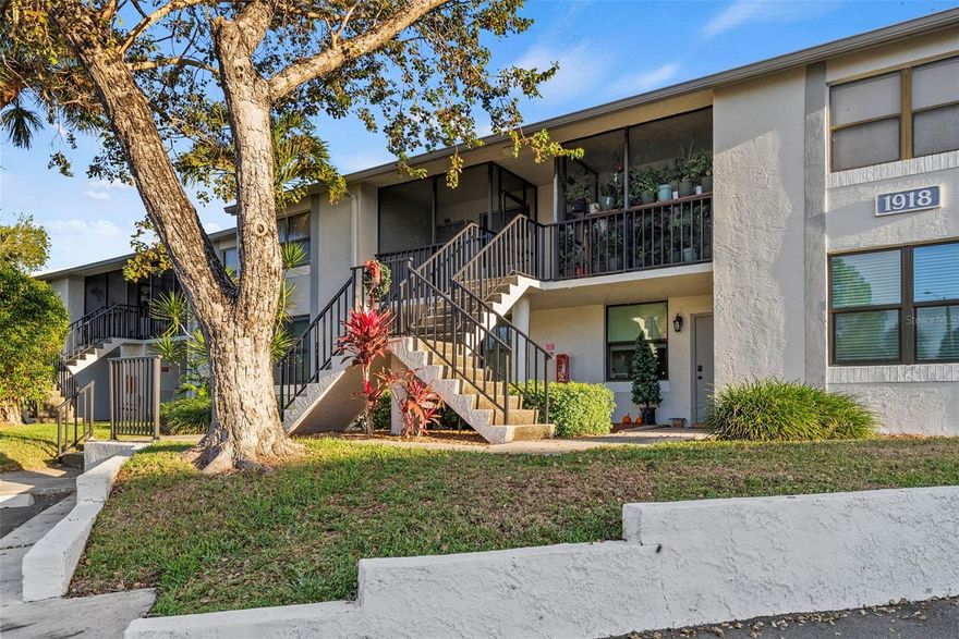 This remodeled second-floor unit features a fireplace and a prime Mid-County location with water views of the pond. Situated in a gated community across from Carillon, it offers quick access to Tampa, St. Petersburg, airports, shopping, and dining. The interior includes an updated kitchen and updated bathrooms, as well as an inside laundry room with a stackable washer and dryer. There is also a covered and screened front porch for the cooler months. The unit is conveniently located across from the community's recreation areas, which includes a pool, spa, tennis court, fitness center, indoor basketball court, clubhouse, and outdoor barbecue. As part of the Feather Sound community, residents also have access to golf, tennis, and social memberships.