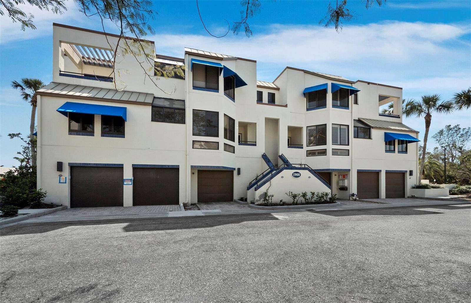 Experience the best of Longboat Key living in this updated 2-bedroom, 2.5-bath townhouse in the exclusive Fairway Bay community, behind the gates of Bay Isles. Offering 1,590 square feet of well-designed living space, this home includes a deeded deep-draft boat slip handling boats up to 40 ft. with no bridges to the bay. The bright interior features light wood floors, recessed lighting, and soaring ceilings with skylights, flooding the space with natural light. The kitchen is equipped with stainless steel appliances, stone counters, a tile backsplash, and a cozy dining nook. Upstairs, both bedrooms offer vaulted ceilings and en-suite bathrooms. The primary suite includes a walk-in shower, dual vanities, and a skylight for added light. The home also has a tandem 2-car garage and an 18' x 11' bonus room for extra storage or a workshop. Enjoy peaceful water views from the screened lanai or take advantage of the private dock for a day on the water. Fairway Bay residents enjoy access to the Bay Isles Beach Club with pristine sand and private lounge areas and it offers deeded beach access, 24-hour security, walking trails, a pool, tennis courts, and a fitness center. For golf and tennis lovers, the Longboat Key Club is nearby, offering world-class courses, tennis facilities, and a full range of resort-style amenities – including the Longboat Key Club Moorings, a full-service deep-water marina with 291 storm-protected slips that can accommodate vessels up to 150-foot. The vibrant shops and dining at St. Armands Circle and Sarasota's cultural attractions are just minutes away.