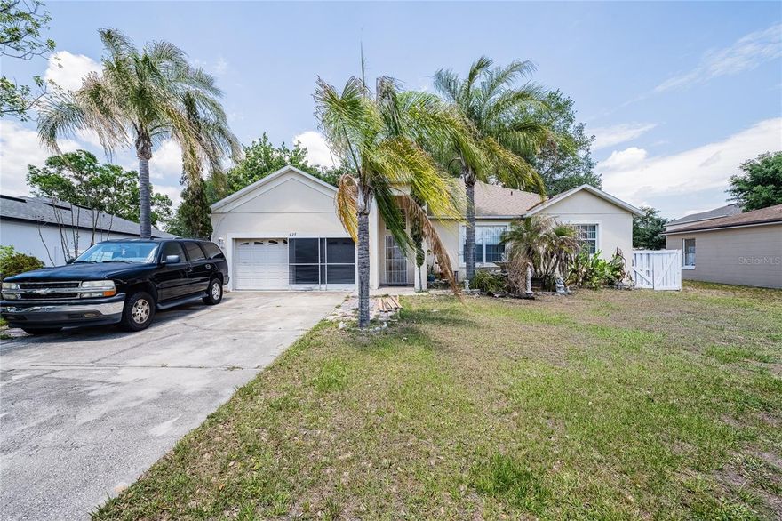 Welcome to this spacious 4-bedroom, 2-bathroom home located in the desirable Poinciana Village community of Kissimmee! Situated on just under a quarter-acre lot, this property offers plenty of space both inside and out.  Step inside to find an open and functional layout featuring a large living and dining area perfect for entertaining or everyday living. The kitchen offers ample cabinet and counter space, a breakfast bar overlooking the living area, pantry storage, and plenty of natural light. Vaulted ceilings throughout the main living spaces create an airy and inviting feel.  The primary suite features a spacious bedroom along with an ensuite bathroom complete with dual vanities, a garden tub, and separate walk-in shower. Three additional bedrooms and a second full bathroom provide flexibility for family, guests, or a home office setup.  Enjoy the outdoors in the fully fenced backyard offering room to relax, play, or garden. A large storage shed with a roll-up door provides excellent storage or workshop potential. Additional features include a 2-car garage, indoor laundry area, and mature landscaping with palm trees that add to the home’s Florida charm.  Conveniently located near shopping, dining, schools, parks, and major roadways for easy access to Orlando attractions and Central Florida amenities.