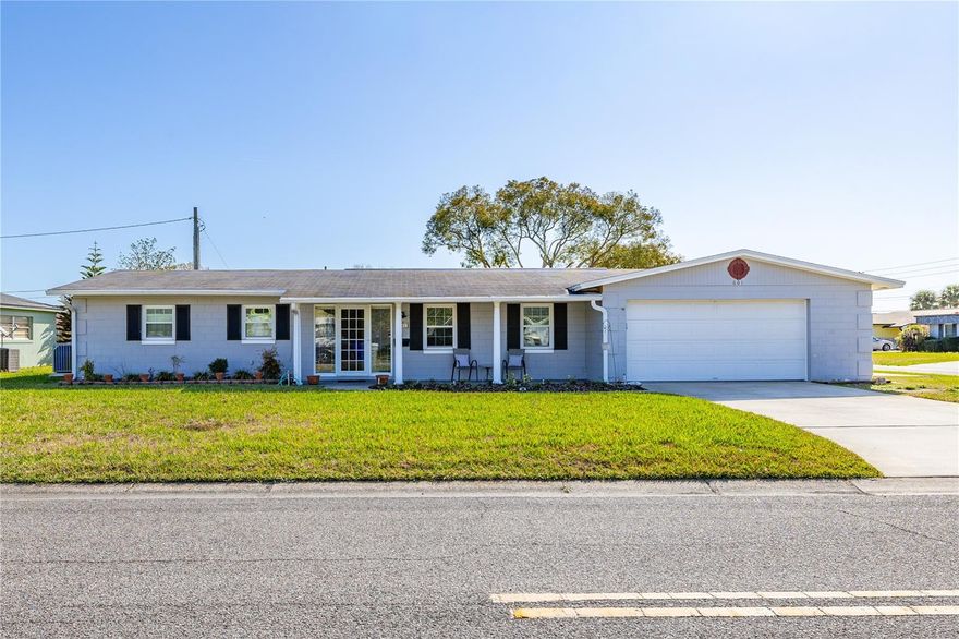 Welcome to this beautifully maintained 4 bedroom, 2 bathroom pool home situated on a spacious .23 acre corner lot. Designed with an open concept layout, this home offers comfortable living and seamless flow between the main living areas. The updated kitchen features granite countertops and ample cabinet space, making it ideal for everyday living and entertaining. Both bathrooms have been tastefully updated. Double paned FAS windows installed in 2015 enhance energy efficiency and allow for abundant natural light throughout the home. Sliding glass doors open fully across the rear of the home, creating a wide opening to the outdoor living space and blending indoor and outdoor areas. Step outside to a large patio area surrounding the pool, providing generous space for seating, dining, and gatherings. The private backyard features a solar heated pool that was resurfaced in 2025, allowing for extended enjoyment throughout the year.  Additional improvements include air conditioning system in 2024 and an electrical panel replaced in 2021.  Conveniently located near shopping, dining, and everyday amenities. The home is close to the nearest elementary school and approximately 20 minutes from Walt Disney World, with easy access to major roadways.