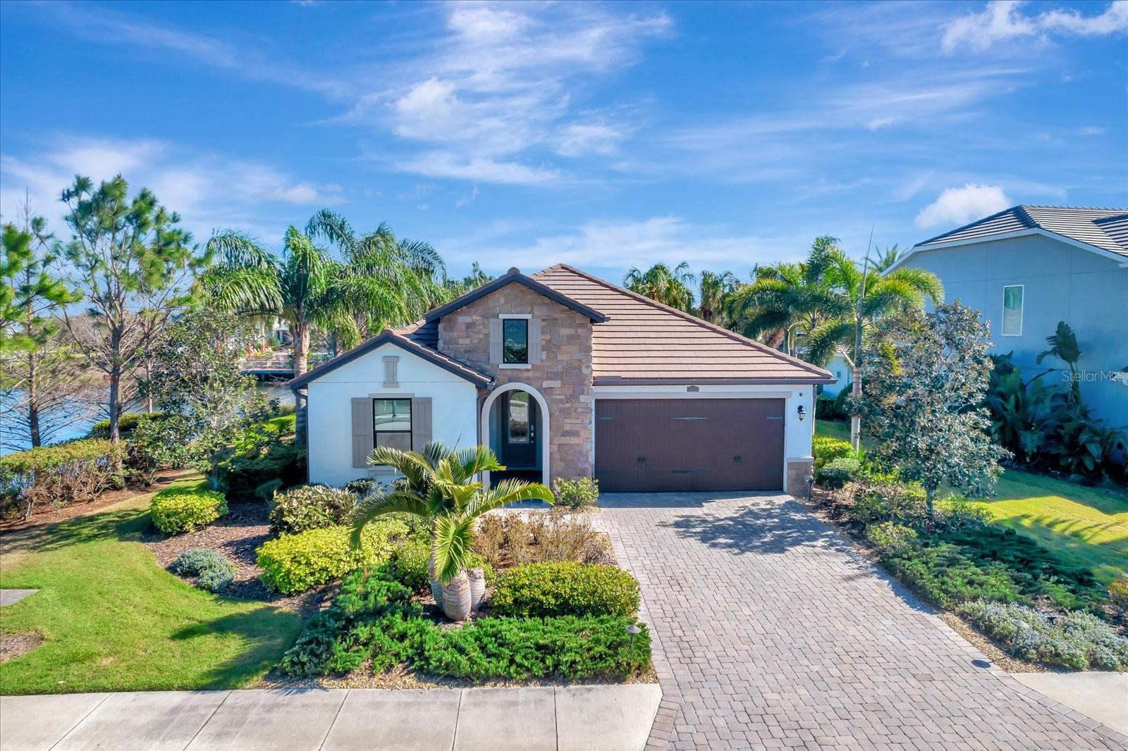 EXQUISITE WATERFRONT MASTERPIECE! This exquisite CalAtlantic Model Home is the epitome of luxury and sophistication. This 3 bedroom, 3 bath, den home has been thoughtfully designed with countless high-end builder upgrades. The former model home sits gracefully on a premium waterfront lot, in a perfect location offering breathtaking panoramic pond views around the home while being just across from the amenity center. SELLER IS OFFERING A BUYER INCENTIVE OF A 2/1 RATE BUY DOWN FOR QUALIFYING BUYERS!
Your new home features a brightand airy interior where every detail has been meticulously curated including the designer furnishings and decor creating an ambiance of effortless elegance. The expansive tiled floors seamlessly flow throughout enhancing the home’s modern and inviting feel. The gourmet kitchen features sleek quartz countertops and premium stainless steel appliances. Soaring tray ceilings, custom built-ins, and oversized double-paned tilt windows fill the space with natural light, highlighting the home’s refined craftsmanship. Luxury extends beyond the interiors this home boasts an expansive waterfront view, extended screened lanai designed for unrivaled outdoor entertaining. Complete with a cozy seating area and a stunning outdoor gas fireplace, this space is perfect for hosting . Additional upscale features include custom drapes, motorized privacy screens, central vacuum system, and wall-mounted TVs throughout as well . Home comes furnished. The elegant curb appeal of this home is undeniable, with architectural stone and shutter details adding timeless charm. A Tesla charger in the garage makes this home as functional as it is luxurious.
Arbor Grande is a vibrant, newer community on the north side of Lakewood Ranch that blends everyday comfort with resort-style living. Residents enjoy a lively social scene, beautiful amenities, and close proximity to local attractions, dog park, bocce ball, fitness center and a beautiful resort style pool its like having a mini vacation every day. The homes are equally impressive—each one thoughtfully designed with standout curb appeal and a range of stylish options.
So don't miss out on this pristine, fully furnished luxury retreat that is ready for you to call HOME!