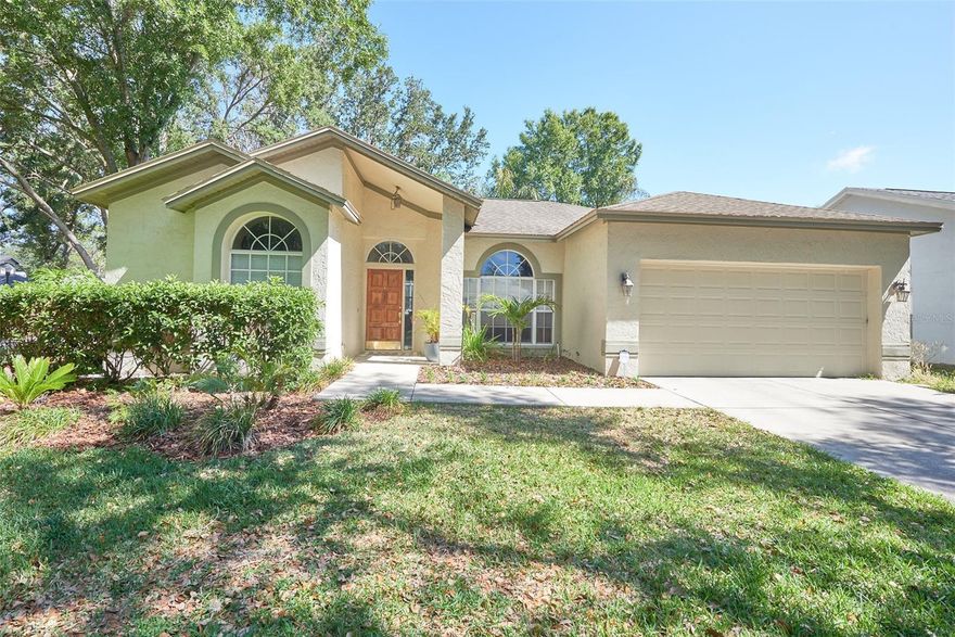 Hunter's Green! Move-In-Ready. Located within New Tampa's premiere gated community, this home has 3 bedrooms, 2 baths and 1837 square feet of living area. Seller offering a HOME WARRANTY!  Mature, tree-lined streets lead to this corner homesite. Upon entering the home, you will see elegant hardwood floors leading to the dining room and living room. The kitchen has a center island with a prep sink, a breakfast bar, a smooth-top stove, recessed lighting, oak cabinets and a separate breakfast nook. The kitchen overlooks the family room and nature views. The family room features ceramic tile, a wood burning fireplace, and triple sliding doors. The master has ceramic tile, a walk-in closet, and nature views. The master bath has dual vanities and a shower. This split bedroom plan offers two additional bedrooms at the back of the home with large windows and ceiling fans. The covered and screened patio has ceramic tile flooring. Hunter's Green has community tennis courts, playground, baseball field, and a picnic area. All of this and more located next to Hunter's Green Country Club, Flatwoods Park, and top rated schools. Easy access to I-75 access to USF, hospitals, shops, restaurants, and Busch Gardens