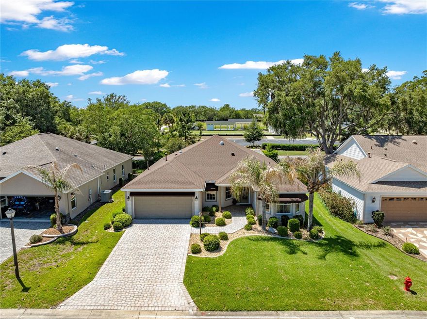 *BOND PAID *NEW ROOF 2023 * NEW HVAC 2019 * UPDATED HOT WATER ON DEMAND * NATURAL GAS * COMPLETE REAR PRIVACY * 2 LANAI SET UP, ENCLOSED UNDER AIR  & SCREENED LANAI * CROWN MOLDING * 
Welcome to one of the most peaceful, picturesque, and highly sought-after designer neighborhoods in The Villages FLORIDA, where tranquility and natural beauty define everyday living. This area is known for its quiet streets, minimal through traffic, and lush, mature landscaping that creates a truly serene setting. Towering trees, manicured lawns, and established greenery line the neighborhood, offering shade, privacy, and a sense of timeless charm that is becoming harder to find. Whether you’re enjoying a morning walk or an evening golf cart ride, you’ll immediately feel the calm, relaxed atmosphere that makes this location so special.

Beyond its beauty, this location offers incredible convenience. Just minutes from shopping, dining, medical facilities, and all your daily essentials, it’s easy to see why this area continues to be one of the top choices for new residents. Those who were fortunate enough to purchase here early on often say they would never dream of leaving—thanks to the perfect balance of peaceful surroundings and close-to-everything accessibility.

This beautifully maintained home features the ever-popular Hibiscus floorplan—now known as the Camellia—offering a spacious, open design that today’s buyers love.

From the moment you arrive, the curb appeal stands out with mature landscaping, a paver driveway and walkway, and charming awnings that add both character and function. Step through the custom glass front door and you’re immediately greeted by elegant ceramic tile laid on the diagonal, enhanced by custom paint, crown moulding, and ceiling fans throughout every room.

The heart of the home is the well-appointed kitchen, showcasing white cabinetry, granite countertops, a stylish backsplash, and a large center island—perfect for entertaining or everyday living. Thoughtful custom woodwork and a solar tube add warmth and natural light, creating an inviting atmosphere throughout.

One of the true highlights of this home is the incredible outdoor living space. Enjoy a double lanai setup designed for year-round Florida living—featuring a screened enclosure for relaxing evenings and a second enclosed lanai complete with a summer kitchen and mini split system, making it ideal for entertaining in any season. Best of all, you’ll appreciate the complete rear privacy—your own peaceful retreat with no neighbors behind.

With so many upgrades and features, this is truly a home you must see in person to fully appreciate. The list goes on and on—schedule your private showing today and experience the beauty, privacy, convenience, and peaceful lifestyle this exceptional property has to offer!
BUYERS AGENT TO VERIFY - BOND BALANCE ZERO -