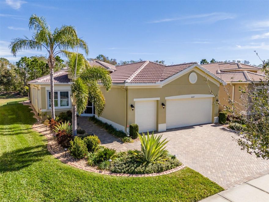 POOL HOME in Valencia Lakes, Tampa Bay’s premier 55+ Active Adult community. 2016 GL Homes built PALAZZO with 2,191sf under air , 3 bedrooms, an office, great room, dining room, kitchen, dinette, 2.5-car garage, and a massive backyard oasis with a gorgeous pool. Exceptionally manicured gardens with landscape lighting, and enclosed river rock  surrounds the whole perimeter creating amazing curb appeal. A large screened-in front portico leads to the French double-door entrance into the spacious foyer with 10’-11’ tray ceiling. Left of the foyer the office basks in natural light from two windows providing a westerly view of the front gardens. Right of the foyer are two generously sized guest bedrooms with lighted ceiling fans and a second full bathroom with a 10mm frameless glass walk-in shower and a spacious laundry room, featuring a MAYTAG Commercial Technology washer & dryer and a practical utility sink. Adjacent to the foyer is the powder room and a built-in linen closet & abundant storage.The superbly well-appointed Kitchen features 42” solid maple chiffon white cabinetry with soft-close drawers and doors and stainless-steel sliding shelves, over & under cabinet lighting, luxurious granite counters topped by a discrete mosaic glass and stainless-steel backsplash, stainless appliances and a single basin sink. Aft of the kitchen is a dinette with two windows overlooking the lanai and pool.The dinette also has a large pantry replete with sliding shelves. A bar-height counter separates the kitchen and the great room.The expansive great room has a 10’-11’ tray ceiling with ceiling fan and 12’ wide glass sliders providing a truly incredible view of the backyard oasis. The roomy primary bedroom features an expansive bay window to capture magnificent sunrises, a high tray-ceiling with a lighted ceiling fan, two custom walk-in closets, and a very large ensuite bathroom. The ensuite bathroom has two separated vanities with Corian counters with integrated sinks capped by wall-to-wall mirrors, a large walk-in shower, linen closet, and a water-closet for the luxury height commode.The backyard features a 330sf lanai with an additional 5’ solid cover and a stunning 30’x15’ gunite pool with a linear fountain, led lighting, and a JANDY heat pump. The pool is enclosed within a 38’x 24 screen room with doors on both sides and the backyard extends another 30 feet to the East. An amazing water view lies North of the property. Signature Collection 9”x60” LVP throughout the home (no transitions), and crown molding graces the roof line. Environmental comforts are assured by a 2022 4-Ton COMFORTMAKER HVAC with a germicidal UV light and MERV 8 filter and a MICROAIR EasyStart Flex Soft Starter on the compressor, Culligan high efficiency water softener system, a Rheem 50-gal water heater with a GRUNDFOS recirculation pump, TECO Zap Cap, Accordion hurricane shutters, and whole-house gutters. This property is exceptional. Valencia Lakes offers a vibrant, resort-style lifestyle centered around a spectacular 40,000 sq.ft.clubhouse featuring live entertainment, dances, more than 100 clubs and a newly renovated Cafe.  Residents enjoy 7 pickleball courts, 6 lighted Har-Tru tennis courts, softball field, bocce, shuffleboard, basketball half court, miles of walking paths, craft studio, card & billiards rooms, community garden, dog park, resort-style pool, resistance and lap pools, sauna and steam rooms, and a 5,000 sq. ft. state-of-the-art fitness center.