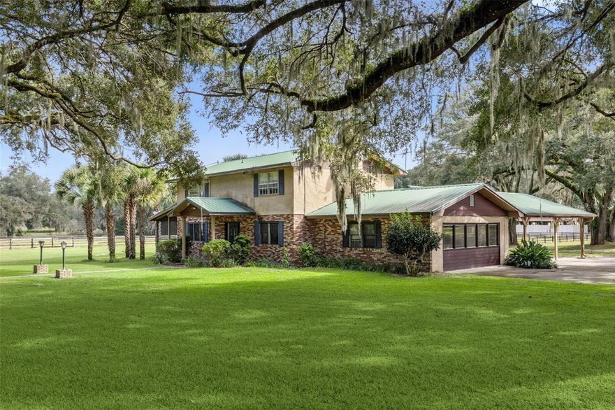 Under contract-accepting backup offers. One or more photo(s) has been virtually staged. Welcome to an elite equestrian estate in the heart of Central Florida’s renowned horse country, offering a rare opportunity for trainers, breeders, and investors seeking a large-scale facility with exceptional income potential. Spanning over 72 fully fenced acres, this legacy property features a 5/8-mile irrigated dirt track, 80-12’X12’ stalls and 4-12’X16’ stalls across three concrete block barns, equine swimming pool, covered eurociser, two covered hot walkers, and 17 four-board pastures and paddocks. Designed for multiple disciplines, including but not limited to training, conditioning, breeding, racing, jumping/hunters, and dressage. The property’s infrastructure supports professional operations of any scale. The barns are thoughtfully equipped with LED lighting, tack and feed rooms, office space, and restroom, while mature oak trees provide shade throughout the grounds. Additional amenities include a maintenance building, three wells, multiple wash bays, and three RV hookups with a separate septic system for on-site accommodations. At the center sits a 2,738 sq.ft., two-story residence with 3 bedrooms, 2.5 baths, a screened porch, and a grand wood-burning fireplace, perfect for owners, staff, or guests.
The property is secured with full perimeter fencing, electric gate entry, and security lighting, ensuring privacy and safety. Located just minutes from Horse Shows in the Sun (HITS) and the World Equestrian Center (WEC), this estate combines prime location, superior infrastructure, and endless potential, a rare opportunity in Florida’s thriving equine corridor. Schedule your private showing today to experience this remarkable property firsthand!
Also listed as a residential property under MLS# O6349209.