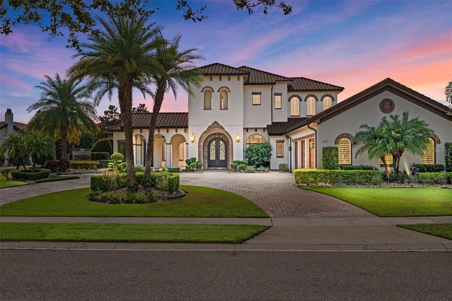 Step into a world of opulence within this former model home by the acclaimed custom builder, Brierhill Homes. Nestled in the coveted guard-gated Waterstone community in Windermere, this property offers the epitome of luxury living.

Comprising 5 bedrooms, 5.5 bathrooms, and a circular driveway leading to an expansive 3-car garage, this residence exudes elegance from the moment you pass through the grand 9’ Cantera design arched steel front door. 

The heart of the home beckons, featuring a formal living room adorned with a fireplace and an expansive dining room capable of accommodating your entire family. These central spaces are enriched with custom columns and exquisite trim work, radiating a sense of style and sophistication.

The chef's kitchen, a true culinary masterpiece, showcases a custom range hood with precast stone and travertine accents above a 36” Professional Series stainless steel natural gas cooktop. Granite countertops with a travertine backsplash complement custom maple cabinets, all accentuated by Thermador appliances. An oversized granite-topped kitchen table comfortably seats up to 8. Adjacent to the kitchen, discover a wine cellar behind a decorative wrought iron door, and a convenient wet bar area with refrigeration.

The primary suite embodies tranquility, boasting a spacious custom closet and a well-appointed bath with a garden tub, shower, dual sinks, and a vanity area. An adjoining office provides a separate outside entrance, complete with a charming courtyard and front porch.

The first floor also offers a second bedroom ensuite with generous closet space, a mud area, and an oversized laundry room replete with ample cabinets and room for a full-size refrigerator.

Ascending the spiral staircase with travertine treads, you'll find a loft/sitting area and three additional ensuite bedrooms, all with spacious closets.

The expansive fenced backyard is a private sanctuary, enhanced by mature landscaping. Here, you can revel in the outdoor kitchen, relax in the pool bath, and bask in the warmth of the fireplace on the screened lanai with wood-paneled ceilings and a travertine deck. The screened saltwater pool/spa, complete with a swim shelf and soothing fountain, can be heated for year-round enjoyment.

This home is replete with remarkable features, including disappearing edge glass sliders in the family room that seamlessly connect to the pool deck. Other notable details include hand-stained ceiling beams in the kitchen, wide plank walnut wood and travertine floors throughout, Restoration Hardware lighting, tankless gas water heaters, built-ins in every corner, a whole-house audio system inside and out, plantation shutters, and the peace of mind that comes with a whole-home Generac backup generator.

Positioned just around the corner from Windermere Preparatory School with private community access, and in close proximity to Windermere High School, Disney, shopping, dining, and the many attractions of Central Florida, this property defines an exceptional lifestyle.