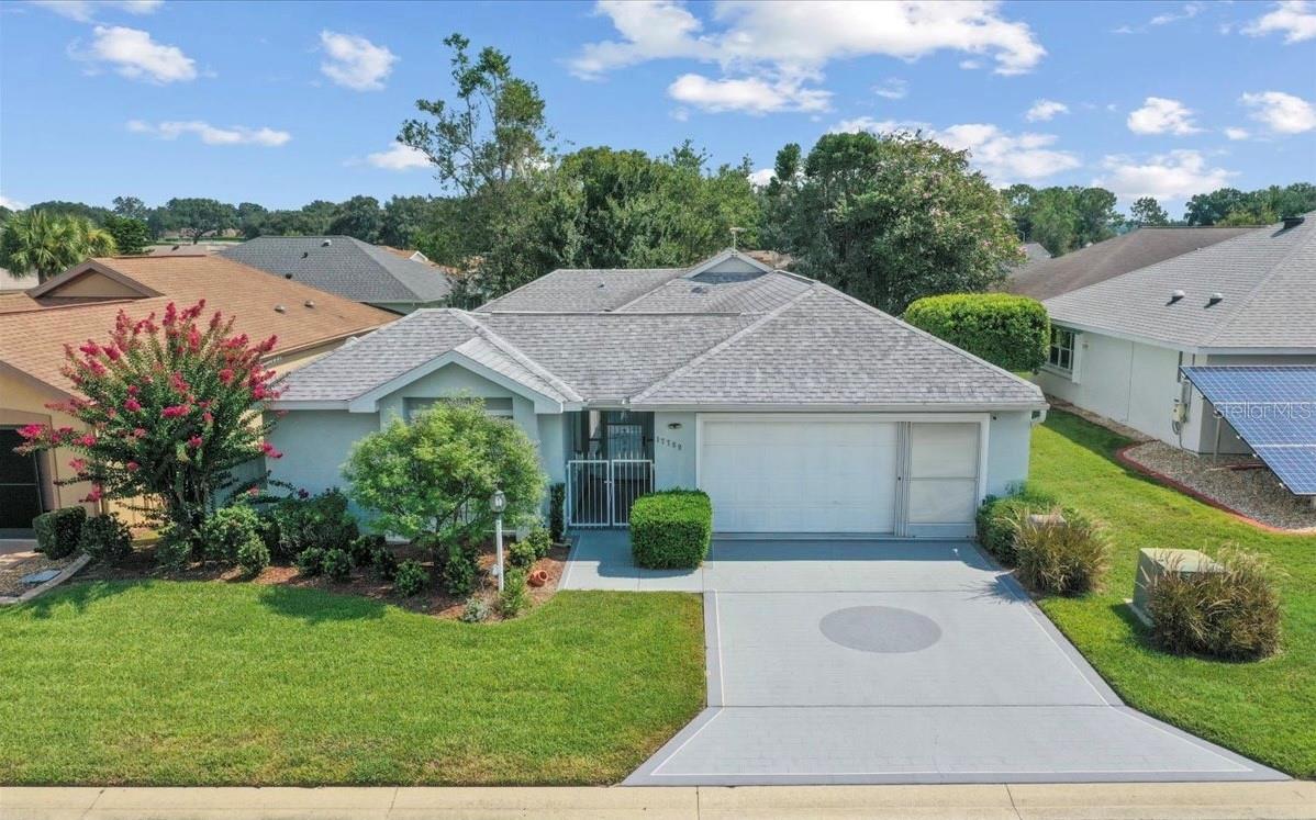 The seller is generously offering a $2,000 credit toward the buyer’s closing costs with an acceptable offer and the listing agent is also offering a 1-year home warranty at closing for added peace of mind! Imagine the many possible uses of a detached third bedroom suite with its own private lanai, a feature that is not available in any other home in Stonecrest. This unique area can be a hobby room, den, home office, rental unit, or guest quarters while being separate from the rest of the house. It has a bath with tub and shower, walk-in closet, wall mounted WiFi streaming TV and sliders to the lanai. A privacy gate allows it to be open to the larger lanai or closed off from it. Location is another major asset, the home is one block from the golf cart gate to Walmart, Aldi, Bealls, Lowes, BJ's, Cracker Barrel, banks, medical offices and a wide variety of other restaurants and commercial establishments accessible within 5-10 minutes by golf cart. It is also a short distance from the 18-hole golf course and social club, community center complex, pools (including an ADA accessible heated indoor salt water pool) hot tub and sports venues.The great room has an open floor plan with luxury vinyl plank flooring, a skylight, and sliders to both the lanai and a room that functions well as a den, TV room, or library. In the kitchen, there are granite countertops, high end cabinet pulls, double sink, pantry, butler pass through/ breakfast bar and tile flooring with a family dining nook. A door to the garage provides convenience for unloading groceries. The guest bedroom fits two beds comfortably, has a wall mounted streaming TV and an adjacent bath with tub and shower. Primary suite has sliders to the lanai, walk in closet, bathroom with skylight. The climate controlled laundry room is strategically located in the garage so wet towels and bathing suits do not have to be carried through the house. The spacious lanai/courtyard, with a roof over the area by the great room sliders, lends itself especially well to entertaining. Large or small groups can be accommodated with or without including your living space. It is also the perfect spot for container gardening, flowers and small fruit trees. The flexible custom design allows the option of inclusion or complete privacy from the third bedroom suite. This home also offers a 1-car garage with dedicated golf cart space and a freshly painted floor. The home is equipped with Netgear WiFi router/modem already installed and connected to the streaming TVs.There are also front yard and back yard Blink security cameras and ADT security system. Stonecrest is a 55+ active adult gated community in Summerfield, FL adjacent to The Villages. Amenities include the indoor pool mentioned above plus 3 outdoor pools, hot tub, fitness center, community center complex with a stage and lighting for theatrical productions, a technology room, card room, tennis, pickleball and bocce courts, corn toss, 18 hole golf course, social club, restaurant, softball field, two dog parks, concession stand and more than 100 clubs and activity groups. Check out the website at https://www.stonecrestonline.com/ and plan to join us in a lifestyle of as much activity or leisure as fits your dreams.