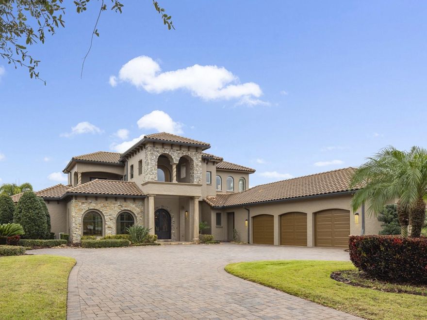 This stunning custom home is ideally located in Windermere's exclusive guard gated Waterstone community. A large pavered drive welcomes you to this beautifully finished estate with double iron entry doors. A formal study is just off the entry and boasts impressive beamed ceilings and seamless views out to the private courtyard and front entry. Just off the foyer are formal areas adorned in custom millwork, travertine floors, and soaring ceilings. The primary suite boats a spacious sitting area, abundant closet space, double vanities, soaking tub and walk-in shower. The fully equipped theatre room conveniently located on the first floor offers stadium seating and top-of-the-line equipment is perfect for movie and game nights. Just off the formal areas rests a massive kitchen with plenty of cabinet space, walk-in pantry, and island that seats six comfortably, and is fantastic for entertaining. The kitchen looks out into the family room with beamed ceilings, custom built-ins and powered blinds. This area opens to the covered lanai with fully equipped summer kitchen, detached pool bath, fireplace, and power screens. All of this overlooks the private backyard, travertine pool deck, and custom pool with waterfall. A secondary guest suite, majestic two-story spiral staircase, and custom fixtures complete the first floor. Upstairs are three additional guest rooms, a loft area, and two full baths with balconies overlooking the manicured grounds and courtyard. Waterstone is located just steps from Windermere Preparatory School, minutes from Disney, shopping, restaurants, and all that Central Florida has to offer.