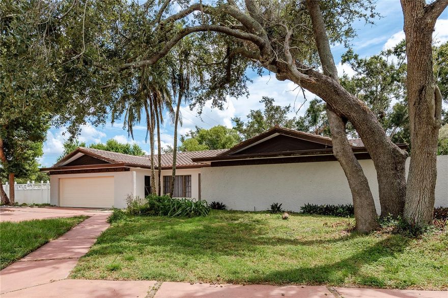 Just listed in Dunedin! Welcome to your Florida lifestyle dream home! Not without its imperfections, but the potential is undeniable. This spacious 4-bedroom, 2.5-bathroom residence is ideally located on the corner of CR-1 & Curlew Rd. Just minutes from the Dunedin Causeway and Honeymoon Island State Park, where stunning sunsets and beach days await. Step inside to find an open, inviting floor plan perfect for both relaxing and entertaining. The bright kitchen flows seamlessly into one of the living areas and overlooks the pool, while generously sized bedrooms provide comfort and flexibility for family or guests. Enjoy an additional space that can be utilized as an office, a hobby room or a reading nook. The laundry room is located inside the heated/cooled space. Outdoors, enjoy your own private retreat with a sparkling pool, large fenced backyard, and plenty of space for gatherings, play, or simply soaking up the sun. Two storage buildings are located on the backside of the home. Abundant space for RV and/or boat parking and the large driveway can accommodate 6-8 cars.  Conveniently located near top-rated schools, shopping, dining, and entertainment, this home truly has it all—comfort, convenience, and a coastal vibe.  Don’t miss your chance to live in one of Pinellas County's most sought-after areas!