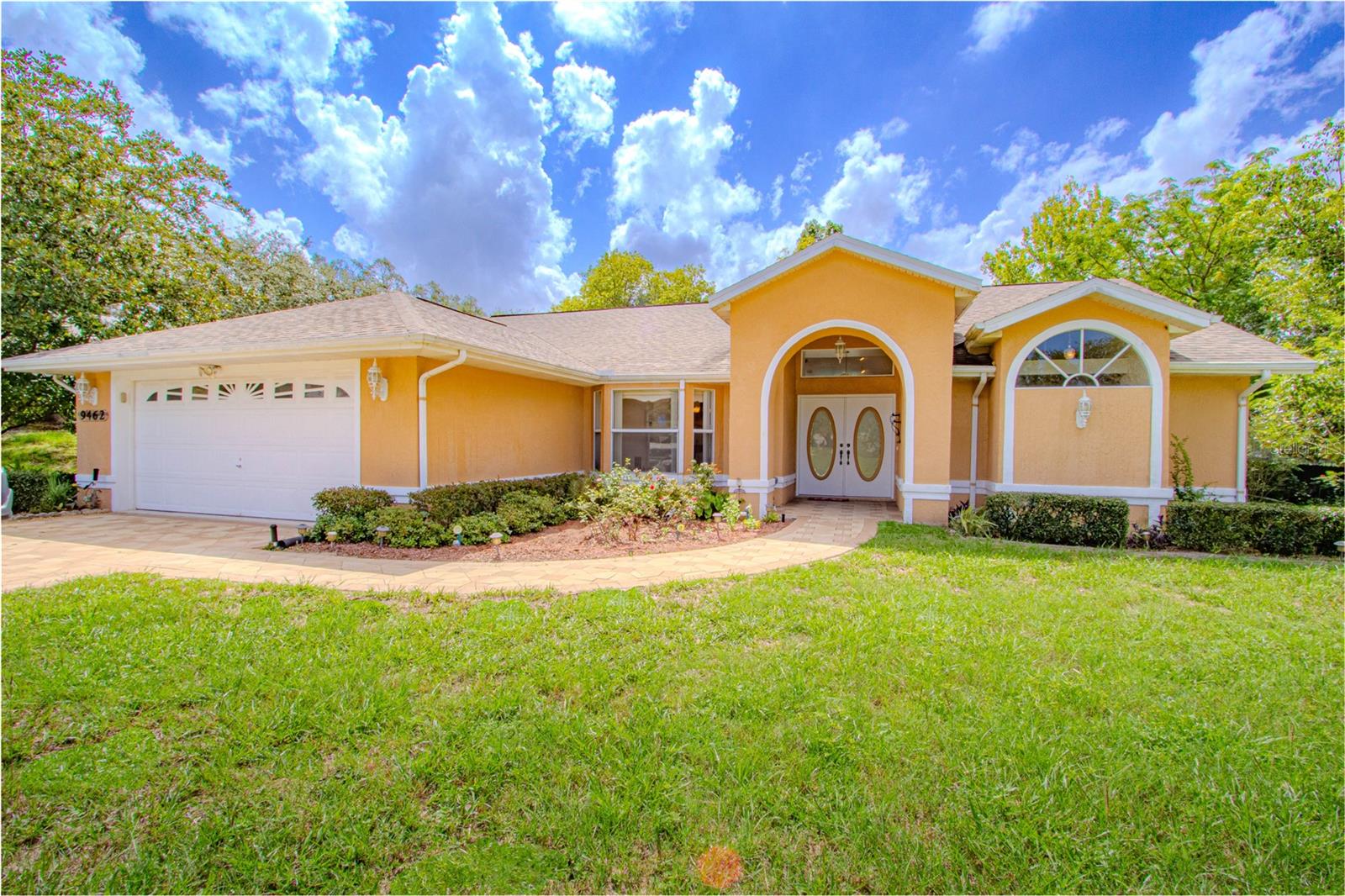 Welcome to this stunning 3-bedroom pool home located in the sought-after Oakridge Estates on an expansive 0.629-acre lot. This beautifully maintained property offers both modern upgrades and charming features, perfect for those seeking space and comfort. Step inside and enjoy the benefits of a newer roof (2018), newer AC, pool screening, ensuring peace of mind for years to come. The split floor plan offers a spacious layout with a bright open living room, dining room, and a separate kitchenette. The heart of the home is the open living area with cathedral ceilings and modern granite countertops and glass backsplash, a cozy wood-burning fireplace, creating a warm and inviting atmosphere. Outside, relax on the expansive lanai overlooking the screened-in, in-ground pool, perfect for enjoying Florida’s sunshine. The oversized 2-car garage offers ample storage space, and the property’s large yard provides a serene backdrop, where you can watch wild turkeys stroll by as you enjoy your morning coffee. This Oakridge Estates gem is the perfect blend of natural beauty and modern living!