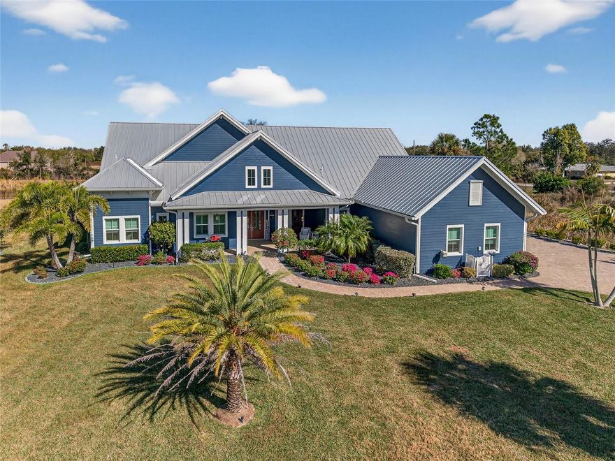 INCREDIBLE COUNTRY RETREAT IN THE ESTATES ON PEACE RIVER JUST 15 MINUTES FROM DOWNTOWN PUNTA GORDA! BOATING ENTHUSIASTS ARE WELCOME AS THE PROPERTY INCLUDES AN OFF-SITE DEEDED BOAT SLIP WITH COVERED 6,000 LB. LIFT ON THE PEACE RIVER WITH ACCESS TO CHARLOTTE HARBOR AND THE GULF! This stunning custom-built home, completed in 2021, offers a rare blend of modern luxury, thoughtful design, and tranquil country living—all set on 1.5 acres with a private lake. As you step inside this amazing 3-bedroom, 4.5-bath pool home with 2,792 sq. ft. of living space, you'll be greeted by an open floor plan featuring soaring 20-foot ceilings, crown molding, elegant lighting, custom shades and porcelain tile flooring in the main living areas. The gourmet kitchen boasts rich wood cabinetry, granite countertops, high-end stainless Smart appliances, built-in oven, and spacious center island with a breakfast bar—all overlooking a welcoming dining area perfect for gatherings. The primary suite is a sanctuary of its own, featuring his-and-hers walk-in closets and a spa-like ensuite bath with dual sinks, soaking tub, and walk-in shower. Two additional guest suites, each with private baths, and a versatile study/den with Murphy bed ensure ample space for family and friends.
Step outside to expansive custom covered lanai highlighting outdoor kitchen with built-in LP gas grill, large center island for entertaining, wood plank ceiling creating cozy atmosphere, automatic StormSmart screens to provide privacy and protection in any weather, screened heated saltwater pool and spa plus brick firepit with underground 500-gal propane tank to enjoy cool winter nights. The beautifully landscaped grounds, adorned with fruit trees like lemon, mango, almond, and lime, add to the home's charm. Additional features include covered front porch to enjoy your morning coffee, large laundry room with extensive cabinetry and Butler's pantry, oversized 3-car garage with A/C and extra insulation, two full-size A/C units and tankless water heater. Standing seam metal roof with commercial gutters, generator plus impact windows and doors offer ultimate peace of mind. Outside, you'll find custom walkways, gazebo, shed for extra storage, and a fenced backyard ideal for your furry friends.
Set within a friendly, private gated community, this home offers both seclusion and convenience, with easy access to US-17, restaurants, shopping, schools, and historic downtown Punta Gorda. Known for its world-class fishing, boating, beautiful parks, and vibrant community events.  Schedule your private showing today and let this extraordinary retreat welcome you home!