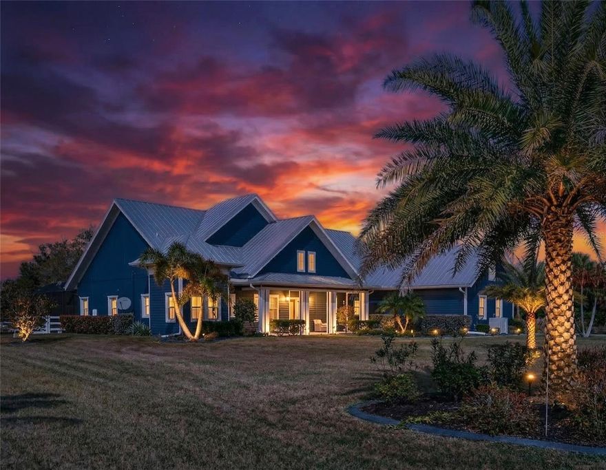 INCREDIBLE COUNTRY RETREAT IN THE ESTATES ON PEACE RIVER JUST 15 MINUTES FROM DOWNTOWN PUNTA GORDA! BOATING ENTHUSIASTS ARE WELCOME AS THE PROPERTY INCLUDES AN OFF-SITE DEEDED BOAT SLIP WITH COVERED 6,000 LB. LIFT ON THE PEACE RIVER WITH ACCESS TO CHARLOTTE HARBOR AND THE GULF! This stunning custom-built home, completed in 2021, offers a rare blend of modern luxury, thoughtful design, and tranquil country living—all set on 1.5 acres with a private lake. As you step inside this amazing 3-bedroom, 4.5-bath pool home with 2,792 sq. ft. of living space, you'll be greeted by an open floor plan featuring soaring 20-foot ceilings, crown molding, elegant lighting, custom shades and porcelain tile flooring in the main living areas. The gourmet kitchen boasts rich wood cabinetry, granite countertops, high-end stainless Smart appliances, built-in oven, and spacious center island with a breakfast bar—all overlooking a welcoming dining area perfect for gatherings. The primary suite is a sanctuary of its own, featuring his-and-hers walk-in closets and a spa-like ensuite bath with dual sinks, soaking tub, and walk-in shower. Two additional guest suites, each with private baths, and a versatile study/den with Murphy bed ensure ample space for family and friends.
Step outside to expansive custom covered lanai highlighting outdoor kitchen with built-in LP gas grill, large center island for entertaining, wood plank ceiling creating cozy atmosphere, automatic StormSmart screens to provide privacy and protection in any weather, screened heated saltwater pool and spa plus brick firepit with underground 500-gal propane tank to enjoy cool winter nights. The beautifully landscaped grounds, adorned with fruit trees like lemon, mango, almond, and lime, add to the home's charm. Additional features include covered front porch to enjoy your morning coffee, large laundry room with extensive cabinetry and Butler's pantry, oversized 3-car garage with A/C and extra insulation, two full-size A/C units and tankless water heater. Standing seam metal roof with commercial gutters, generator plus impact windows and doors offer ultimate peace of mind. Outside, you'll find custom walkways, gazebo, shed for extra storage, and a fenced backyard ideal for your furry friends.
Set within a friendly, private gated community, this home offers both seclusion and convenience, with easy access to US-17, restaurants, shopping, schools, and historic downtown Punta Gorda. Known for its world-class fishing, boating, beautiful parks, and vibrant community events.  Schedule your private showing today and let this extraordinary retreat welcome you home!