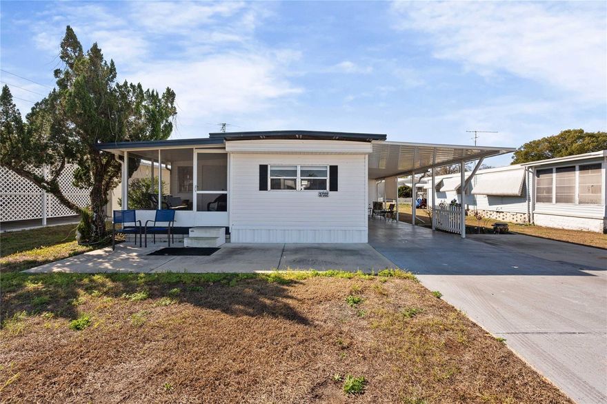 Welcome to Betmar Acres, an active 55+ golf community where you OWN your land and enjoy a low annual community fee of just $448! Nestled on a quiet street within the community, this nicely updated home offers comfortable Florida living with thoughtful improvements and extra space for entertaining family and friends. Inside, you’ll appreciate the split-bedroom floor plan, providing privacy for both residents and guests. Bedroom two conveniently includes its own half bathroom, while the main bathroom features a step-in shower and linen storage. Water-resistant laminate flooring flows throughout the main living areas, creating a clean, low-maintenance look. An additional living area has been added to the home, expanding the square footage and providing extra room to relax, entertain, or create a cozy sitting area. The home also features an updated tankless hot water heater and a metal roof that was freshly coated with protective sealant in 2025, offering added peace of mind. Outside, the double carport and additional parking pad provide plenty of room for guests. The attached storage area includes shelving, a washer and dryer, and space for your golf cart—perfect for getting around this friendly golf-cart community. Betmar Acres offers a vibrant lifestyle with 27 holes of golf, swimming pools, pickleball, shuffleboard, clubs, activities, and social events year-round. The community is conveniently located near shopping, restaurants, and premier medical facilities, and just a short drive to Tampa and St. Petersburg International Airports as well as some of Florida’s beautiful Gulf Coast beaches. Schedule your private tour today and come discover the relaxed Florida lifestyle waiting for you in Betmar Acres!